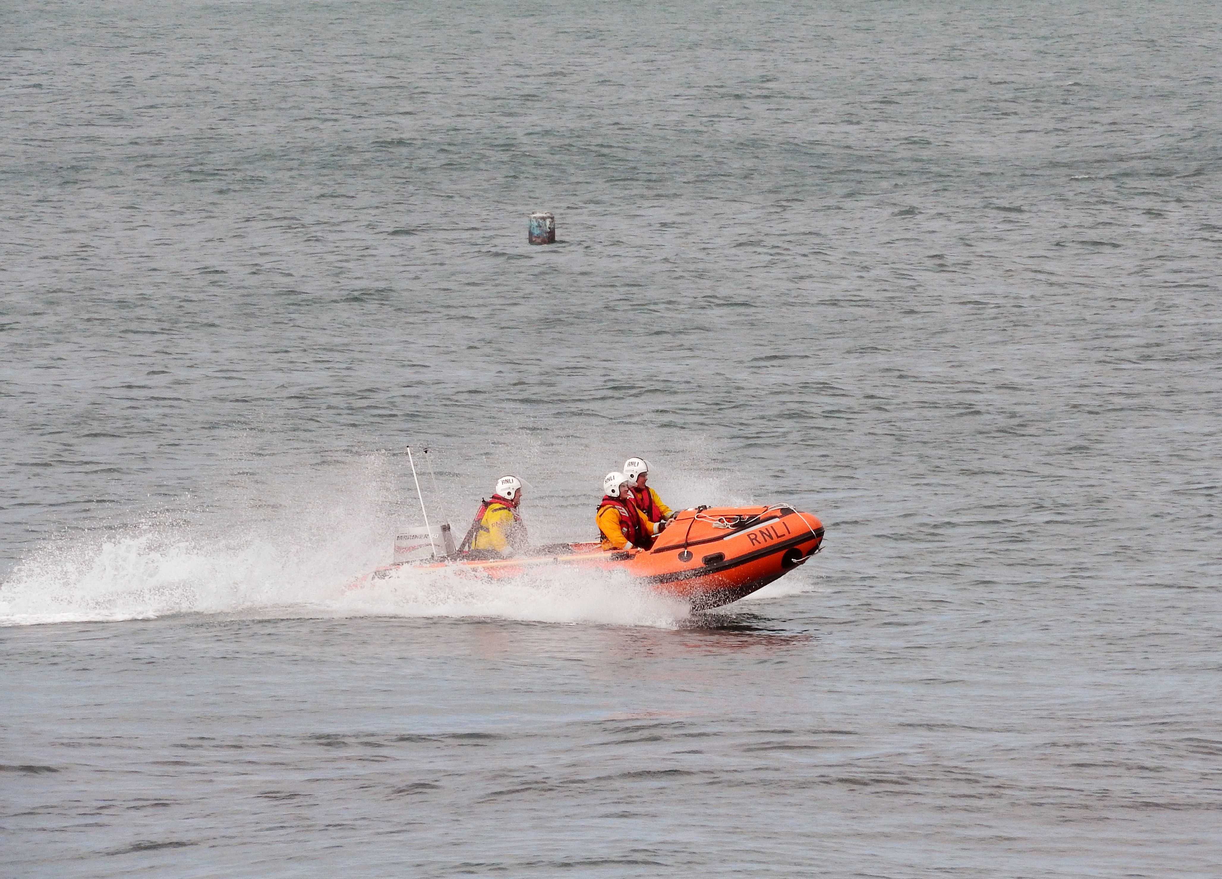 Wicklow RNLI Inshore lifeboat launching on service to swimmers at Silver Strand.
