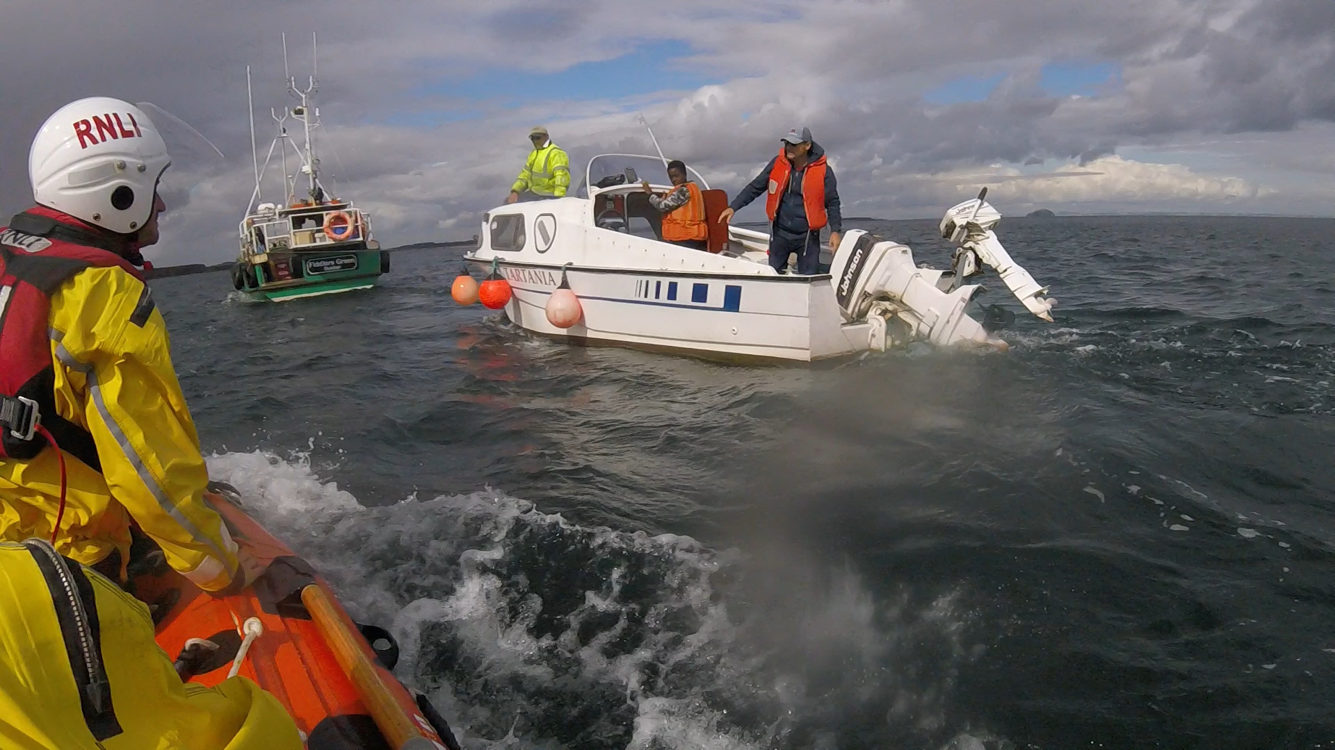 Shows Dunbar ILB crew on scene as pleasure craft Tartania is towed by fishing vessel Fiddler's Green.