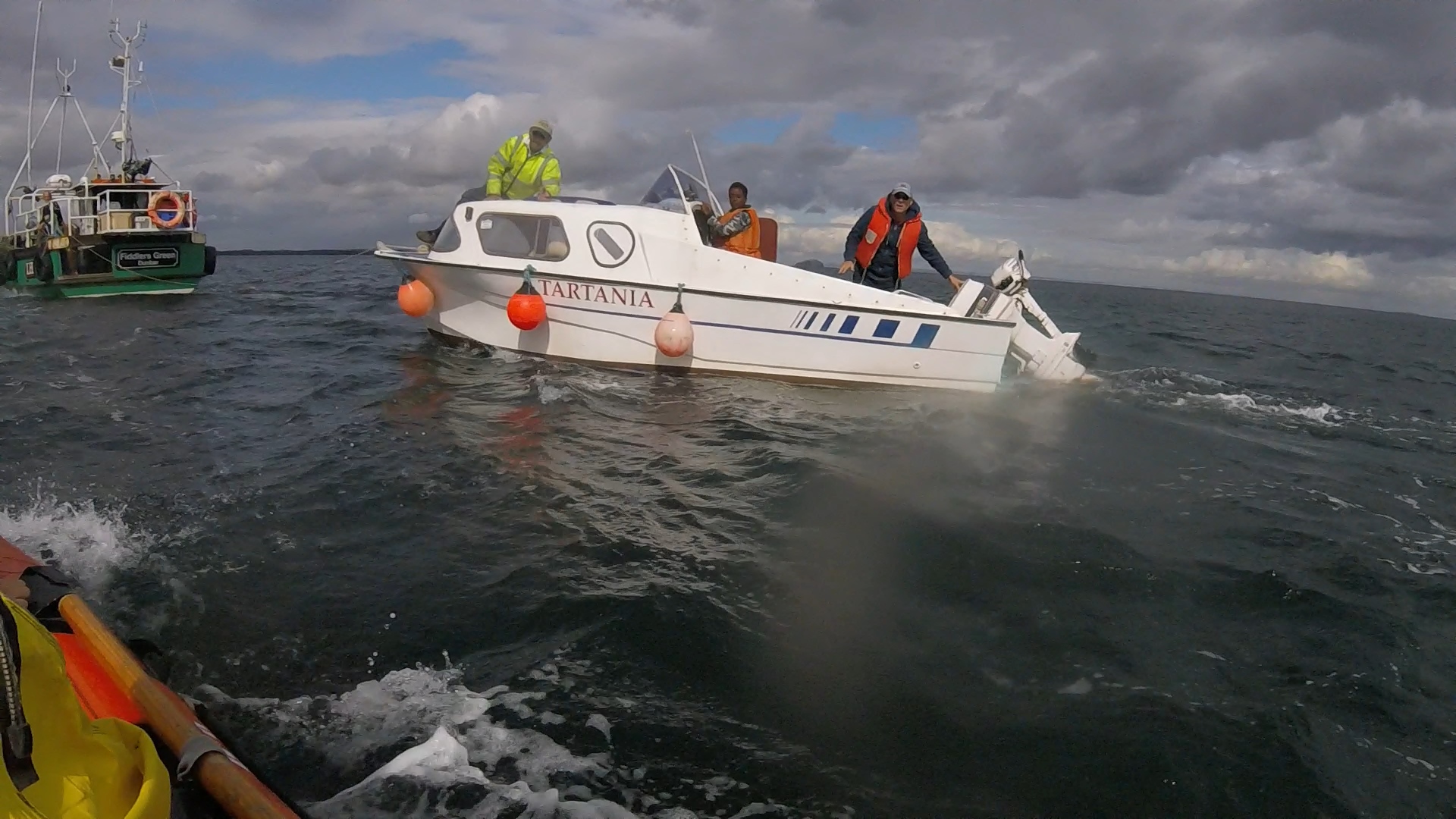 Shows Dunbar ILB crew on scene as pleasure craft Tartania is towed by fishing vessel Fiddler's Green.