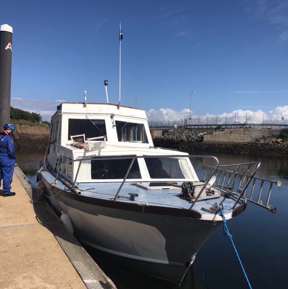 The casualty vessel alongside in Troon Marina with Ayr Coastguard Rescue Team