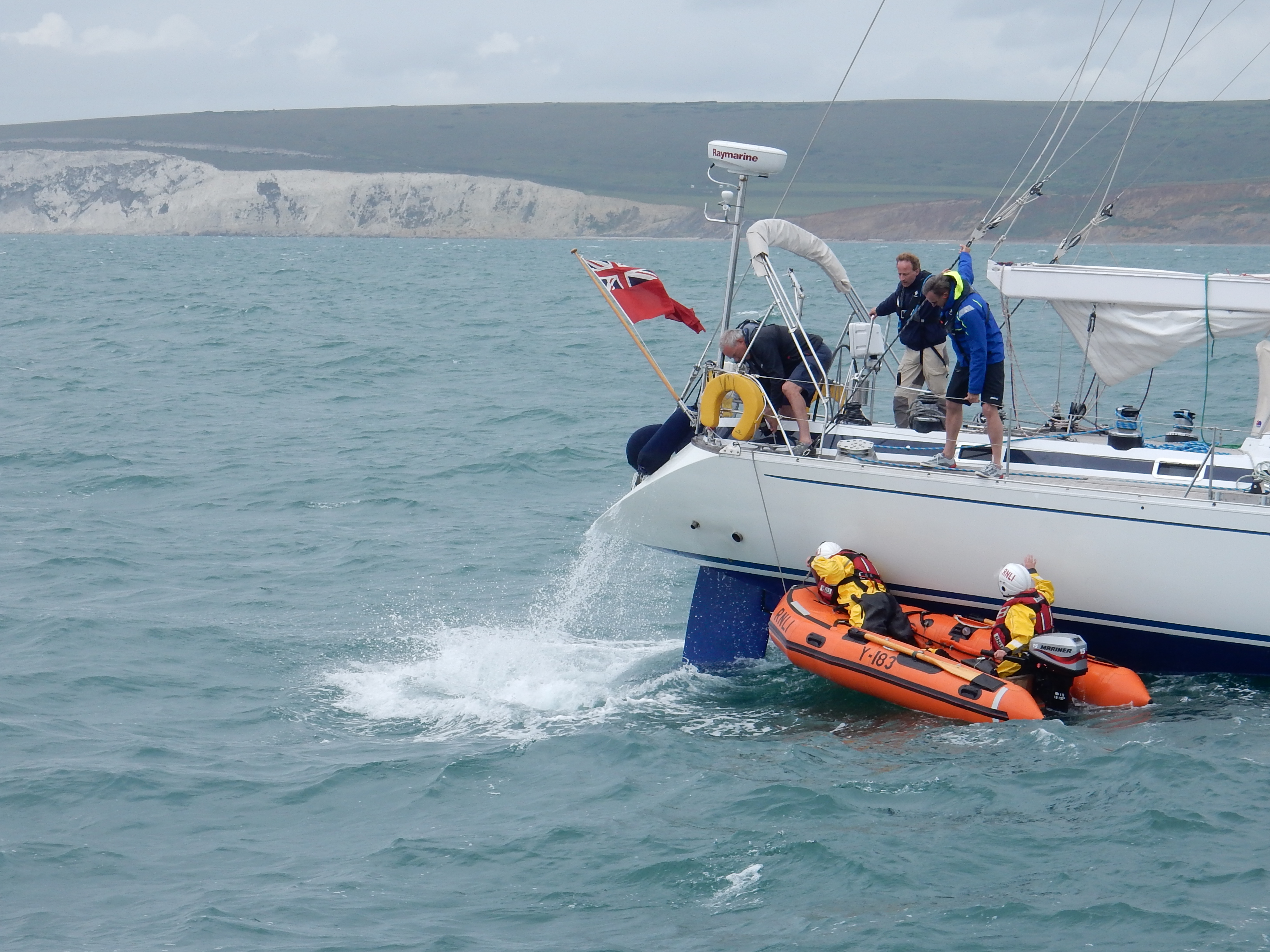 The crew of Yarmouth RNLI in their 'Y' boat assist the crew of the yacht