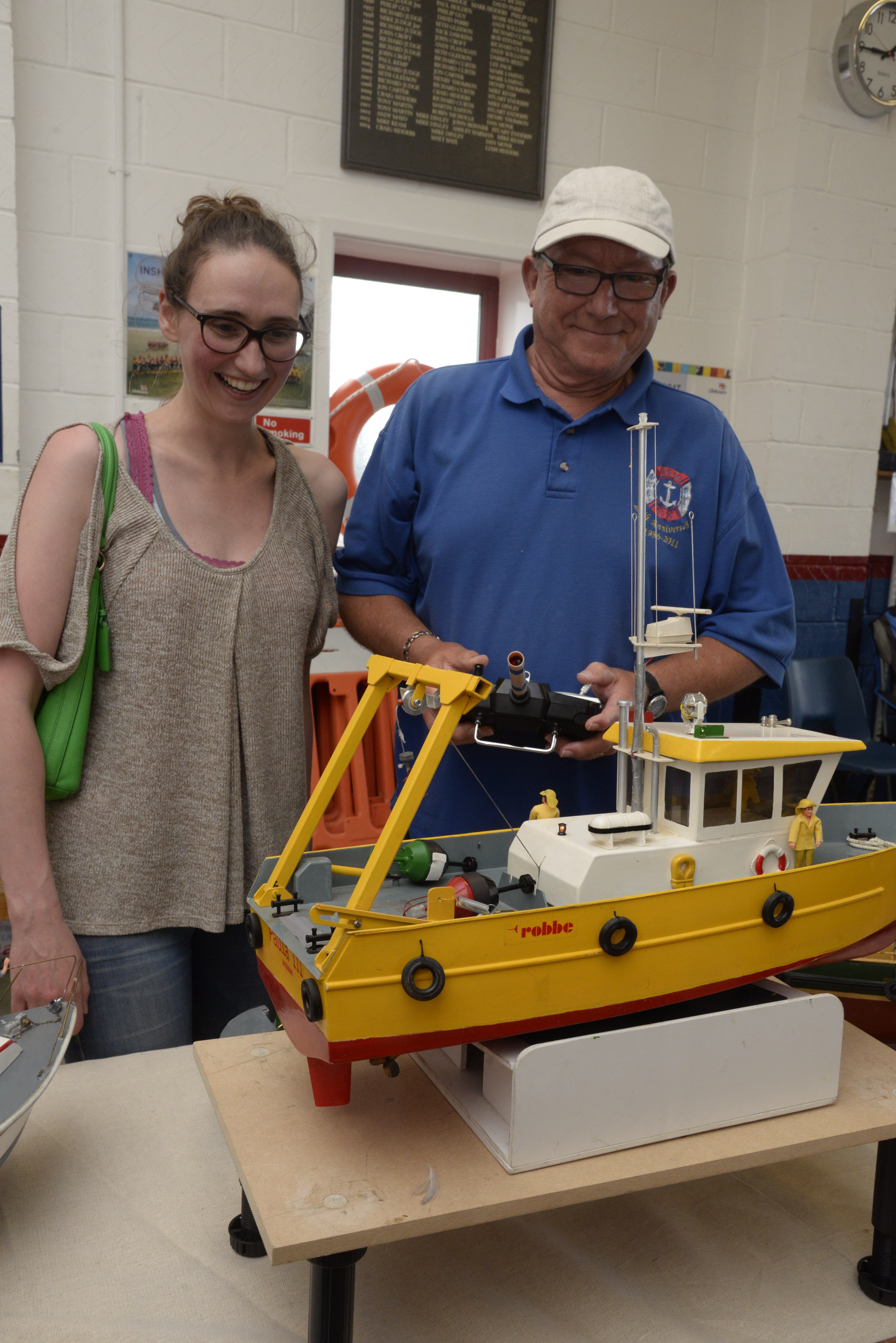 Emma Schofield admires Peter Champion's 'workboat' at the model boat exhibition at Whitstable Lifeboat Station on Sunday. Picture: RNLI Whitstable