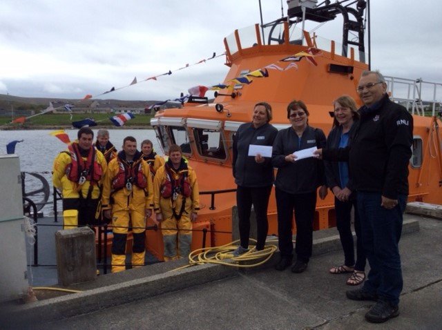 RNLI Aith Lifeboat Operations Manager accepting donation from Co-op staff members