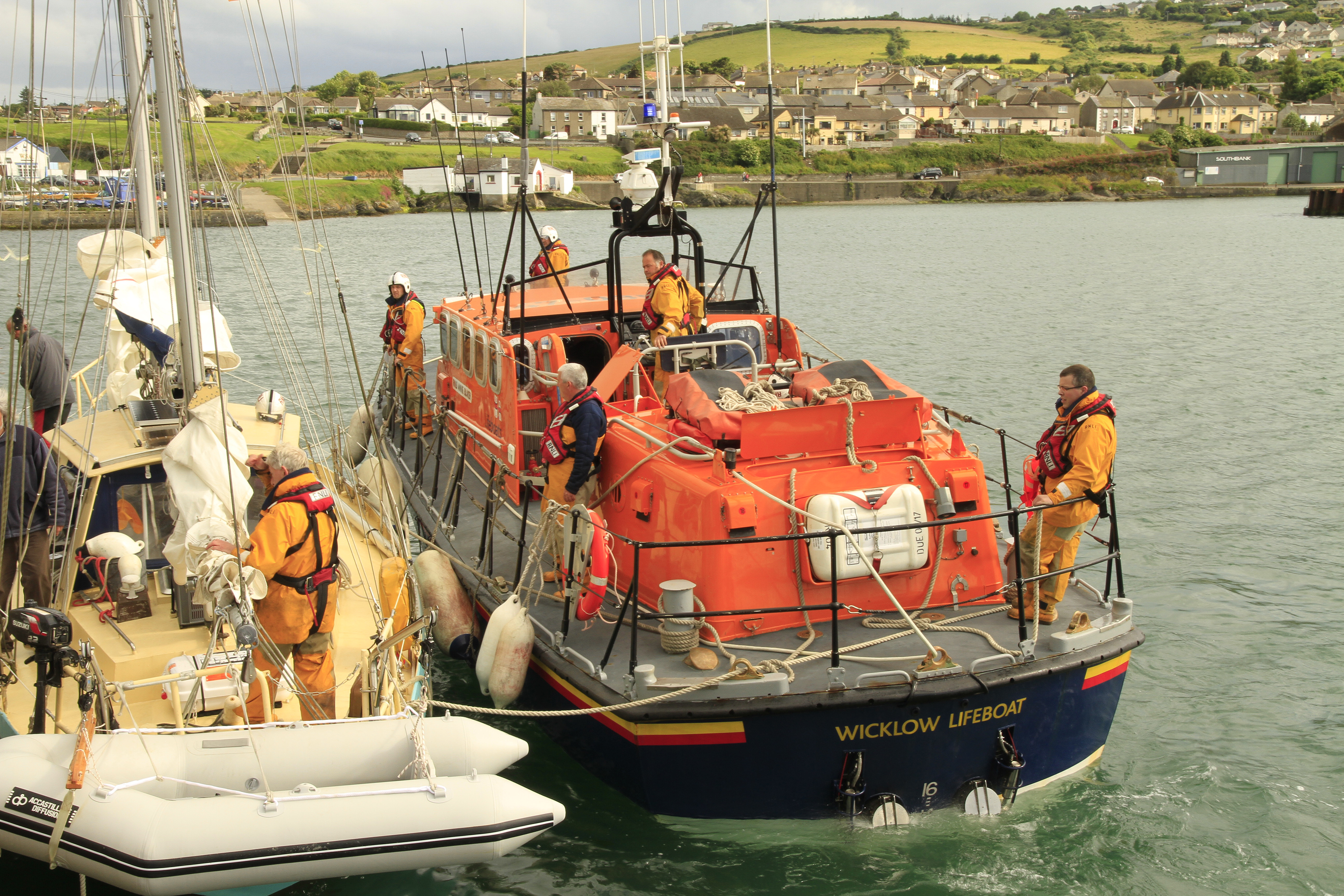 Lifeboat crew secure the french yacht alongside the East pier at Wicklow harbour