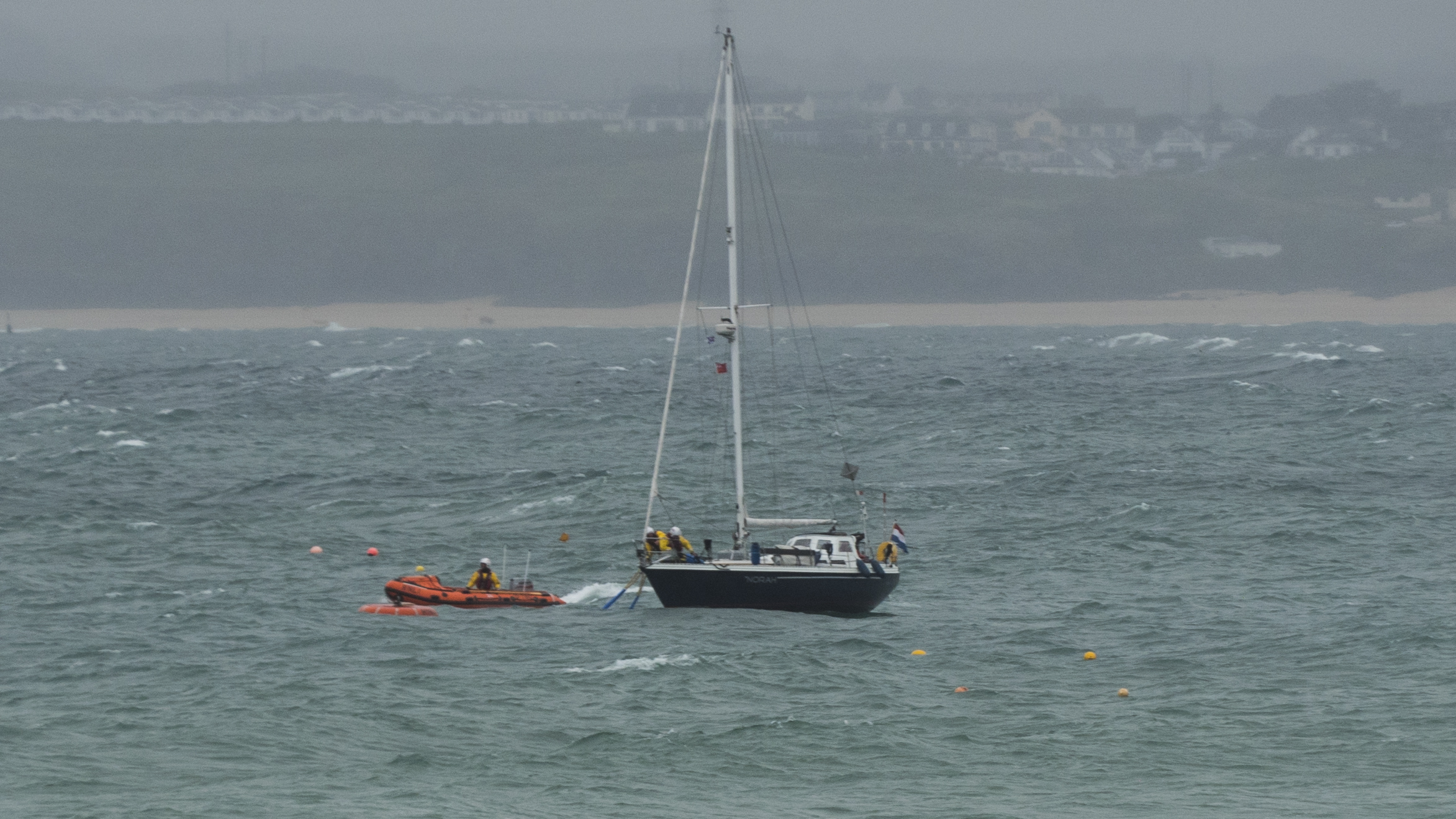 Crew members Jack Coop and Peter Tanner onboard yacht to help with mooring.