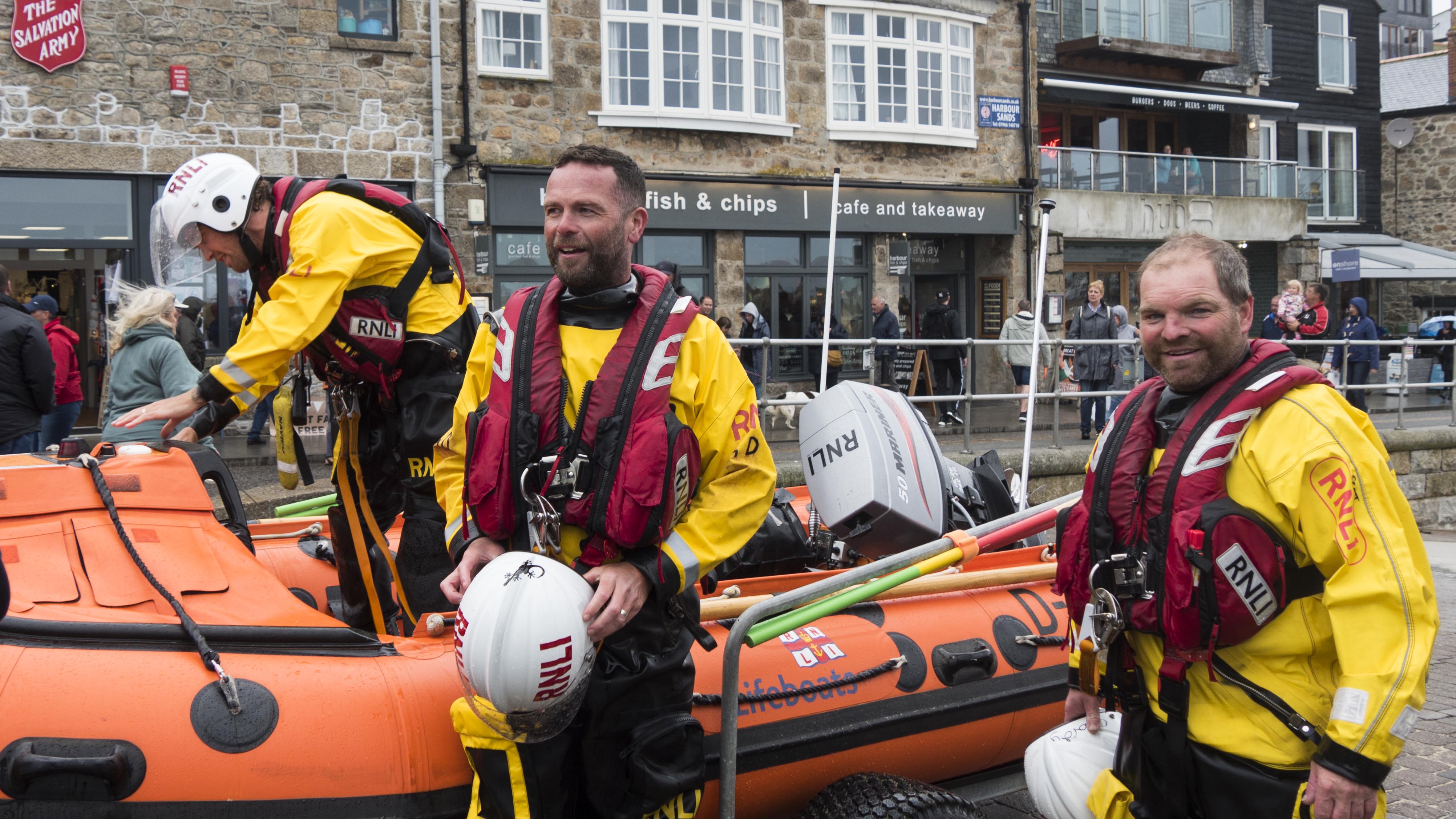 Crew member Jack Coop, Helm George Deacon and crew member Peter Tanner return to the station.
