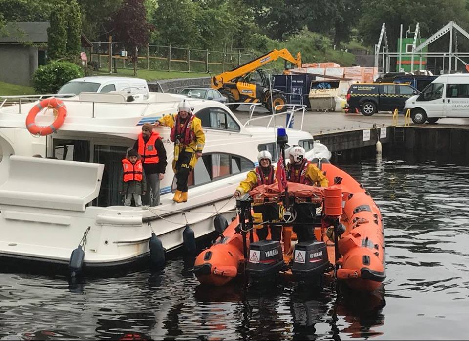The casualty vessel safely back in harbour with the Loch Ness Lifeboat Colin James Daniel alongside and the new Loch Ness lifeboat station under construction in the background
