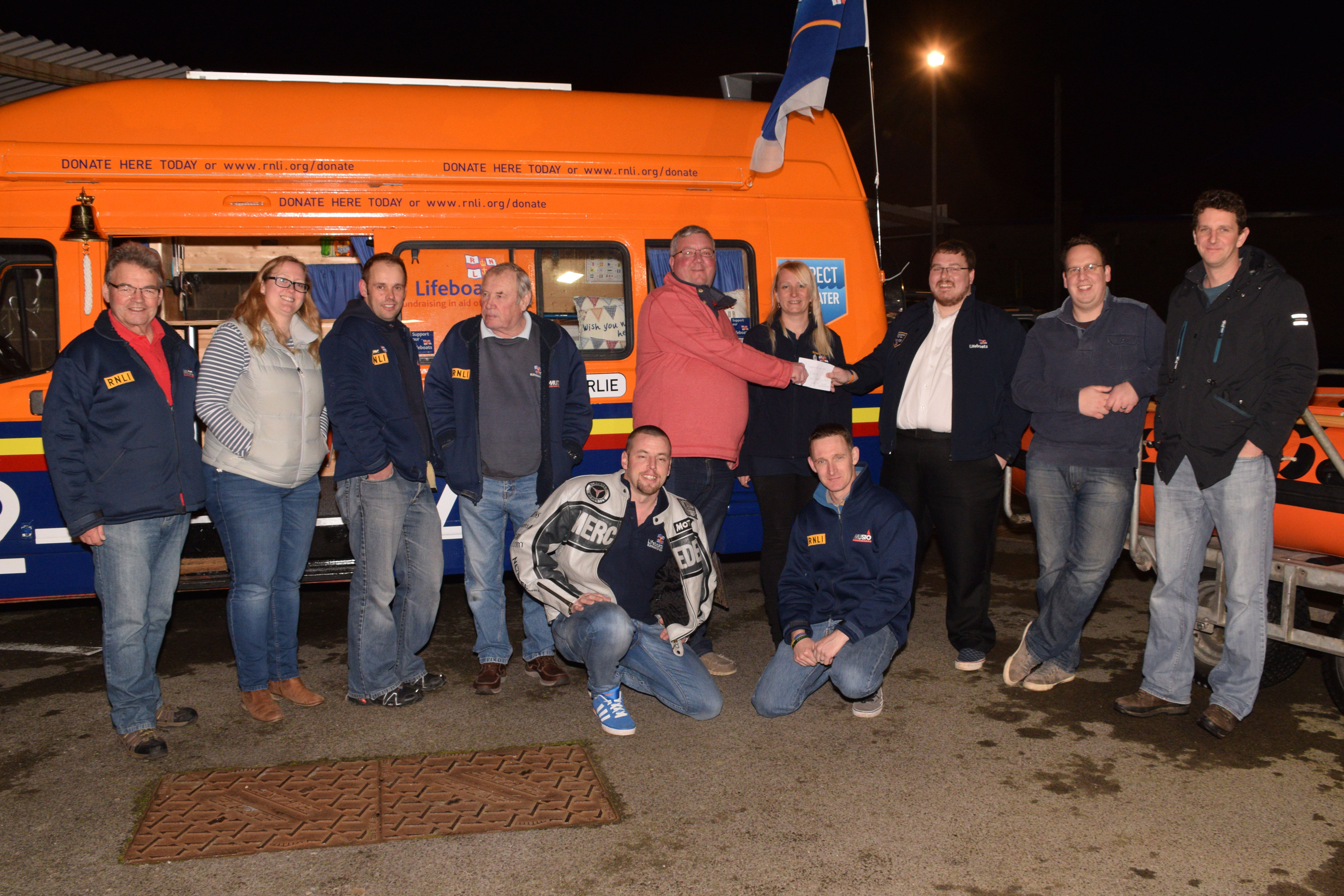 Jared handing over the collected funds to Operations Manager Matt Davies