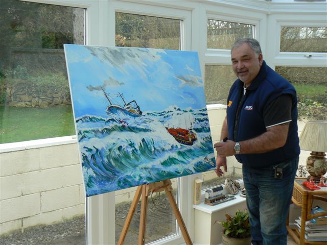 New Quay RNLI Coxswain Daniel Potter with his painting of the Frank and Lena Clifford of Stourbridge, ﻿which will be auctioned to raise money for the Stourbridge RNLI Fundraising Branch