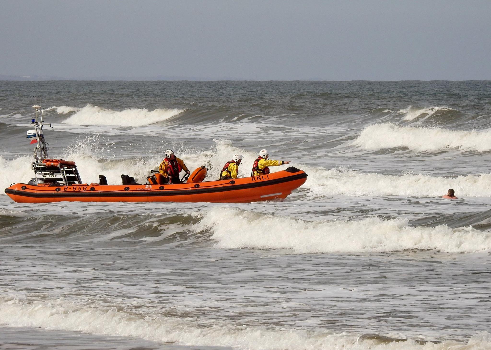 Redcar RNLI lifeboat approaching a woman in the sea at Saltburn