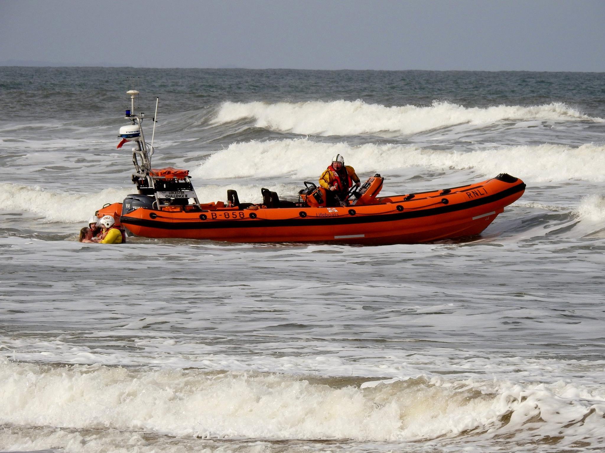 Redcar RNLI crew jump into the sea to rescue a woman at Saltburn