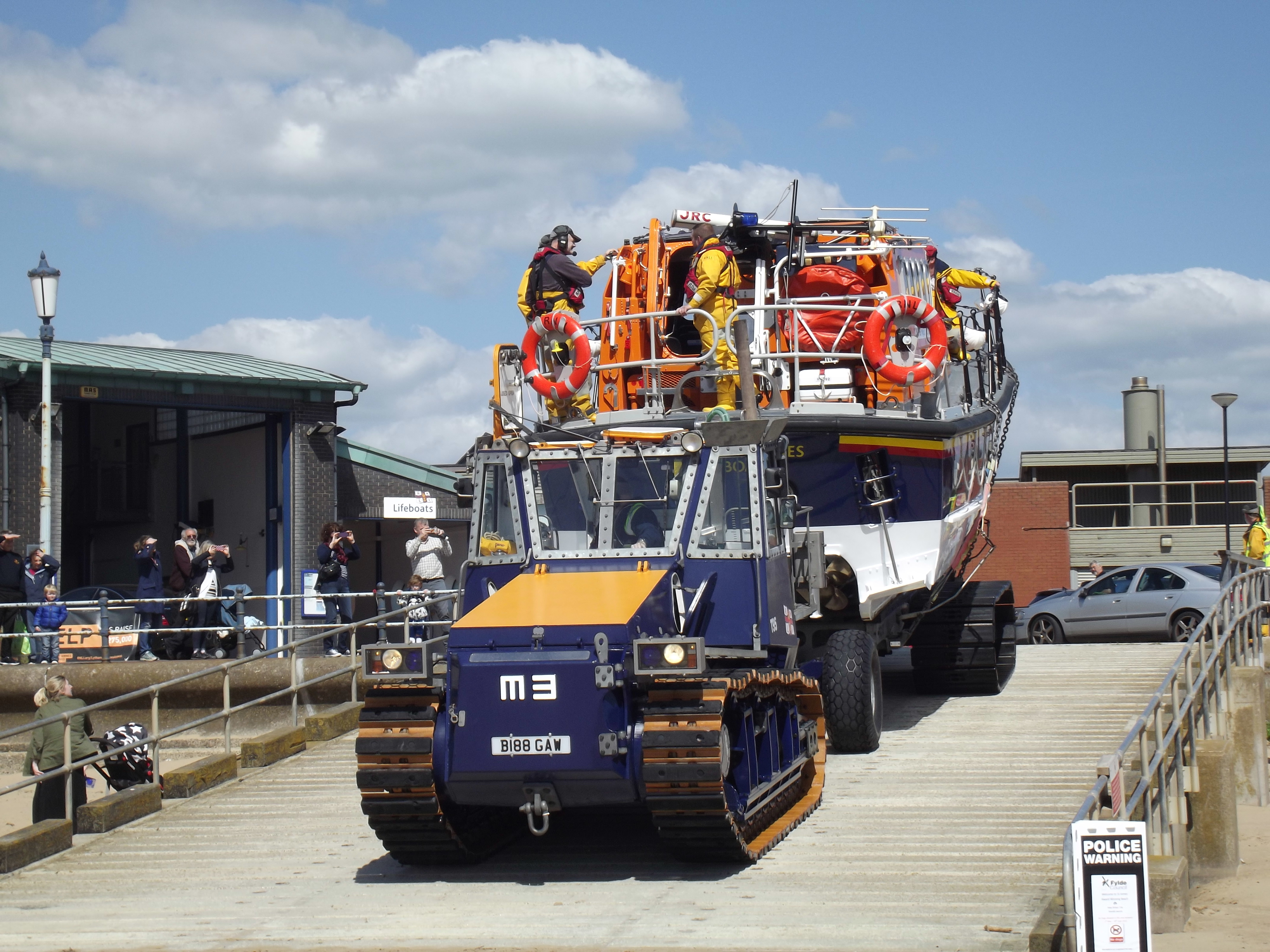 Lytham St Annes Mersey class Lifeboat on her carriage and pulled by the tractor heads out to rescue the broken down yacht