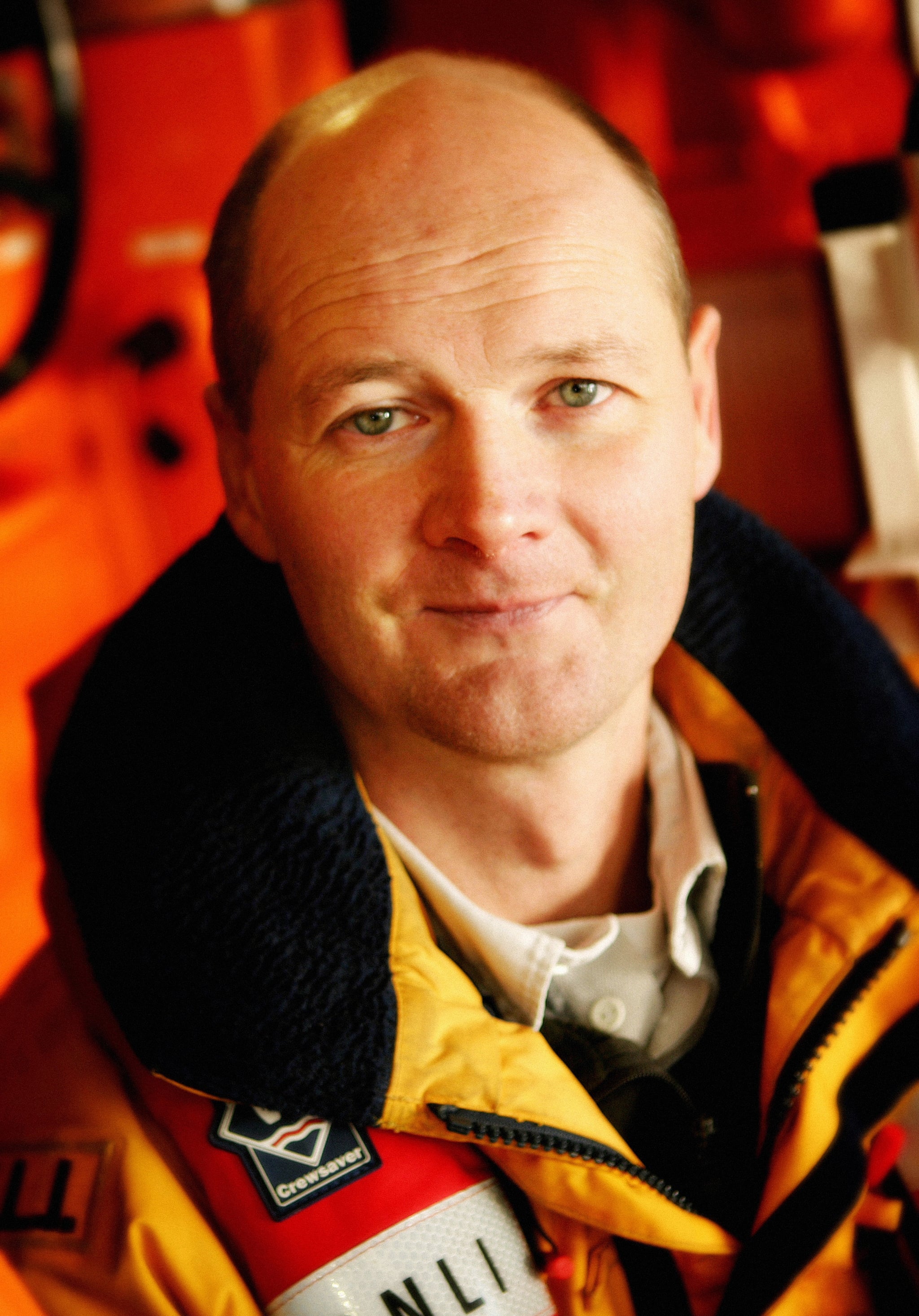 Lifeboat crew member Deputy 2nd Coxswain Nick Glassbrook wearing his lifejacket and waterproof coat