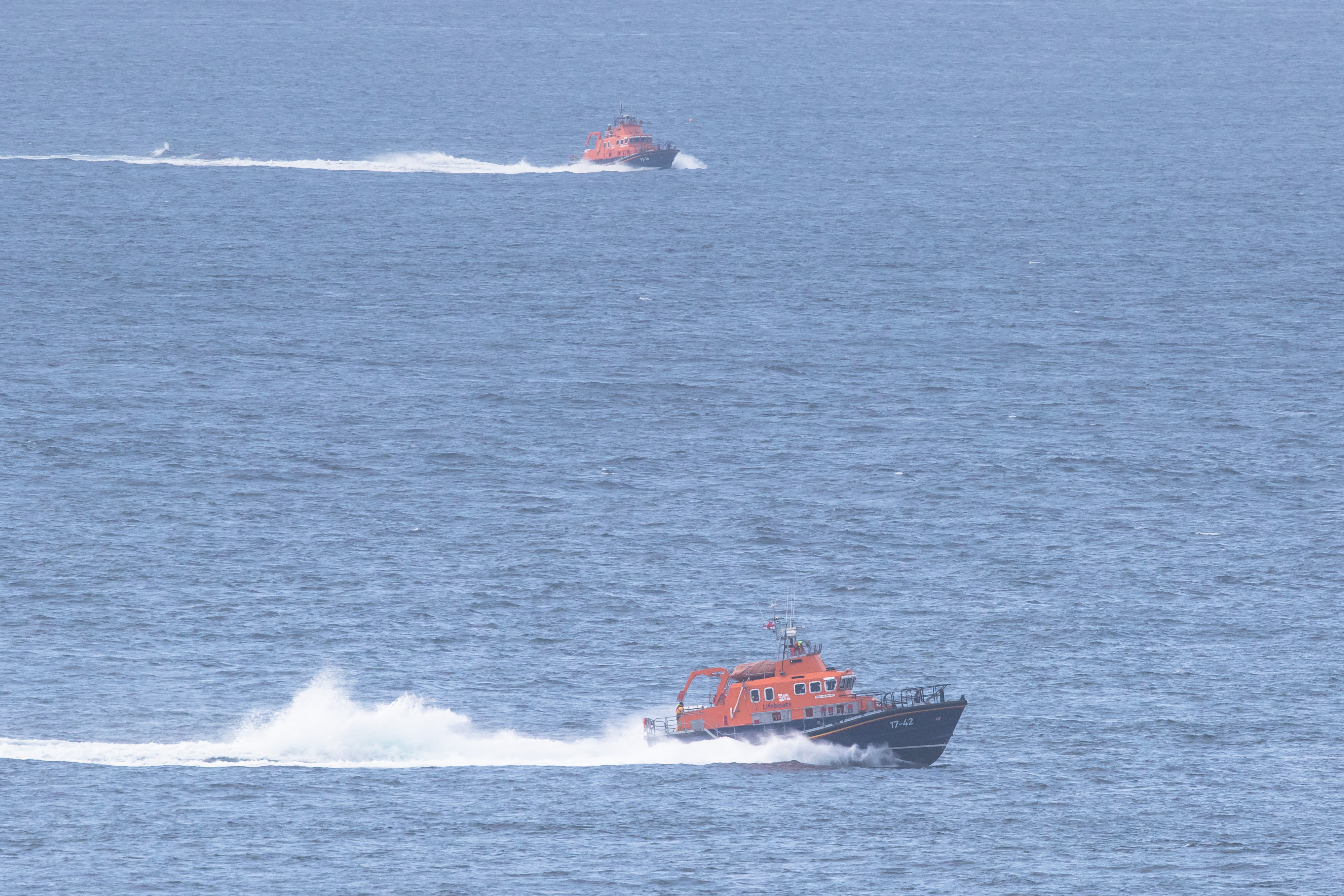 Thurso Lifeboat in the foreground, with Stromness Lifeboat searching the Pentland Firth
