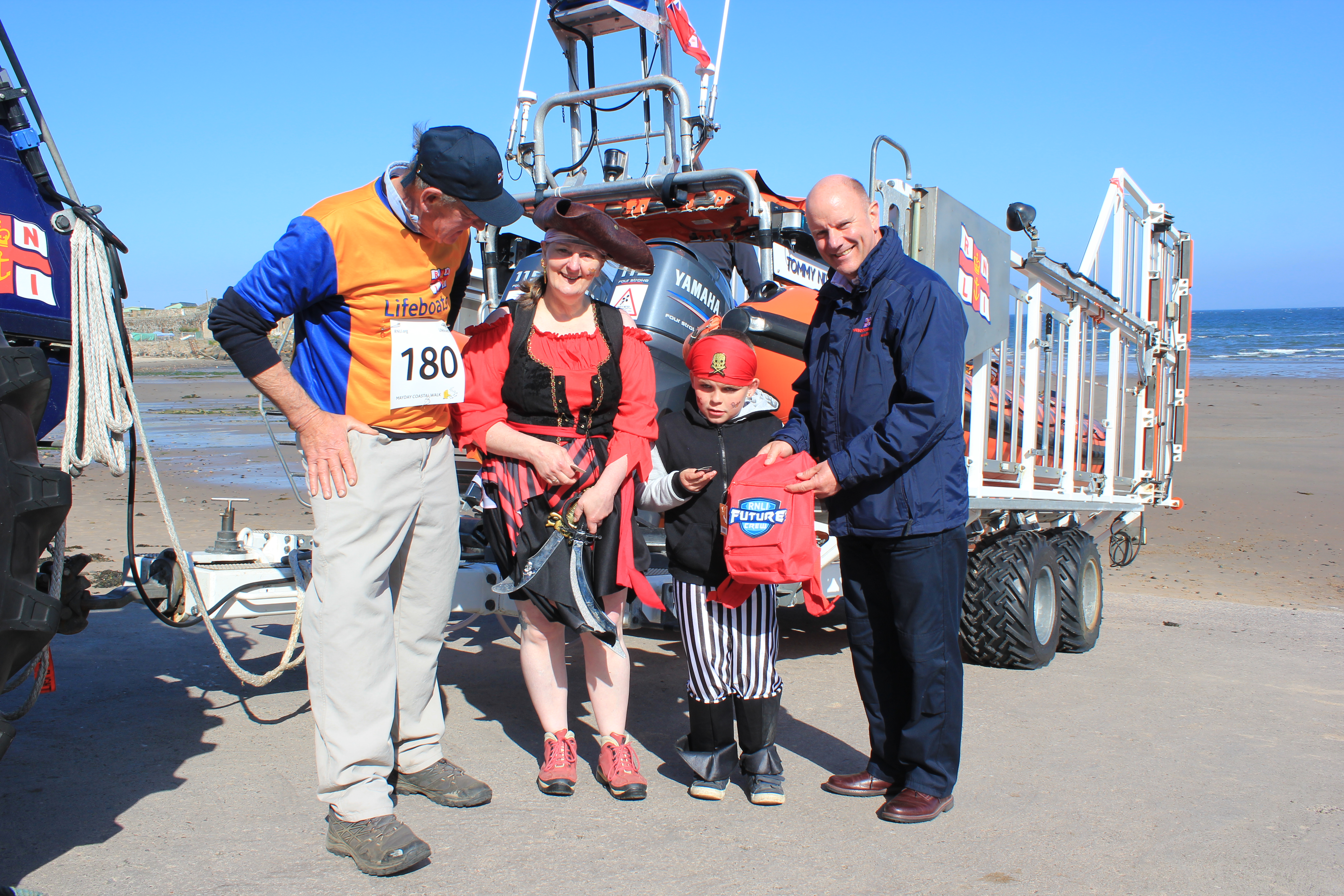 10yo Cody Davie is presented with a RNLI bag to mark his completion of the Coastal Challenge