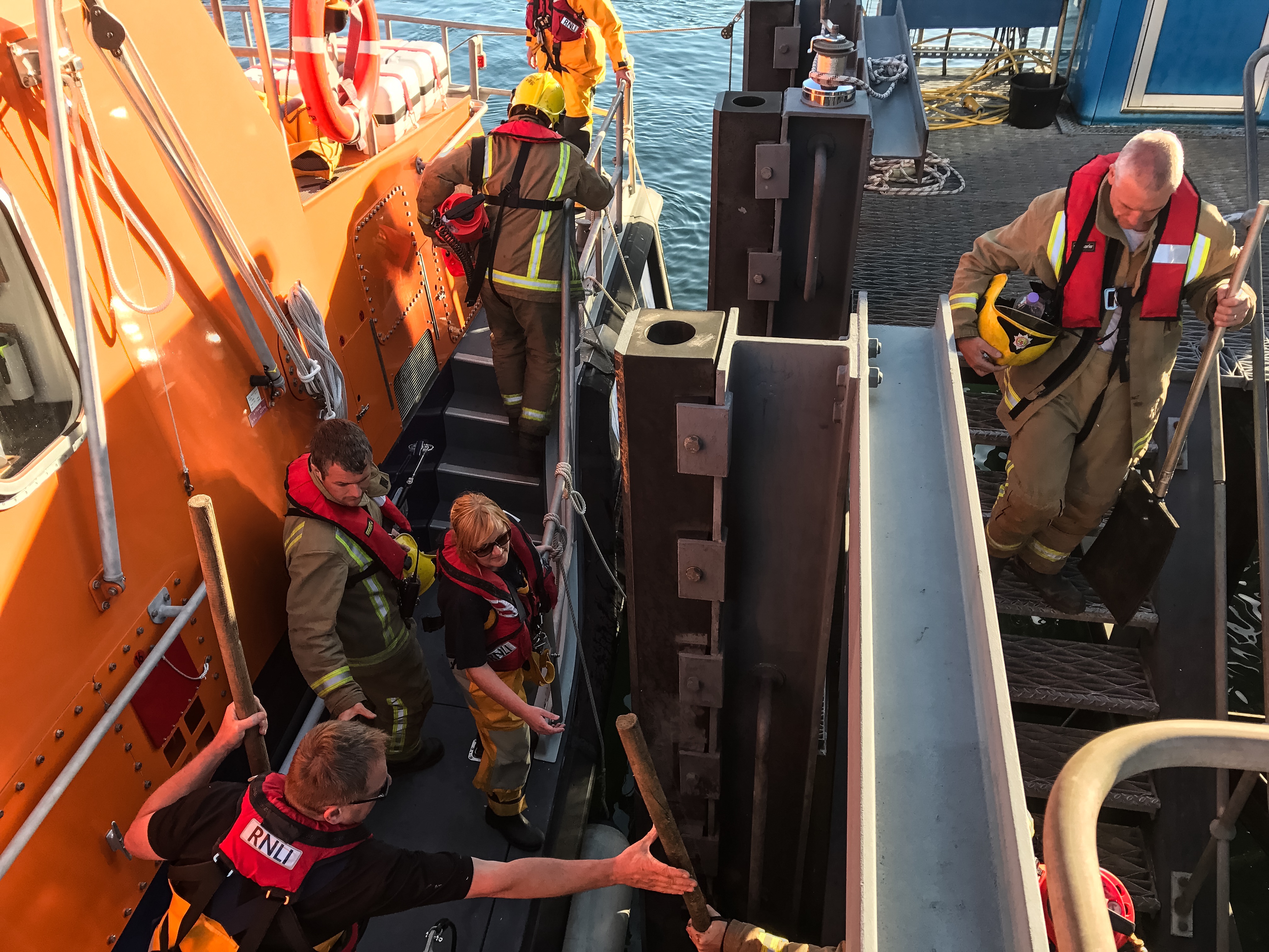 Tobermory retained firefighters board Tobermory lifeboat to be taken to Calve Island