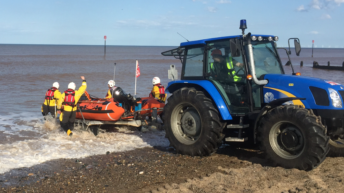 The Withernsea lifeboat is launched into the sea by its marinised agricultural tractor.