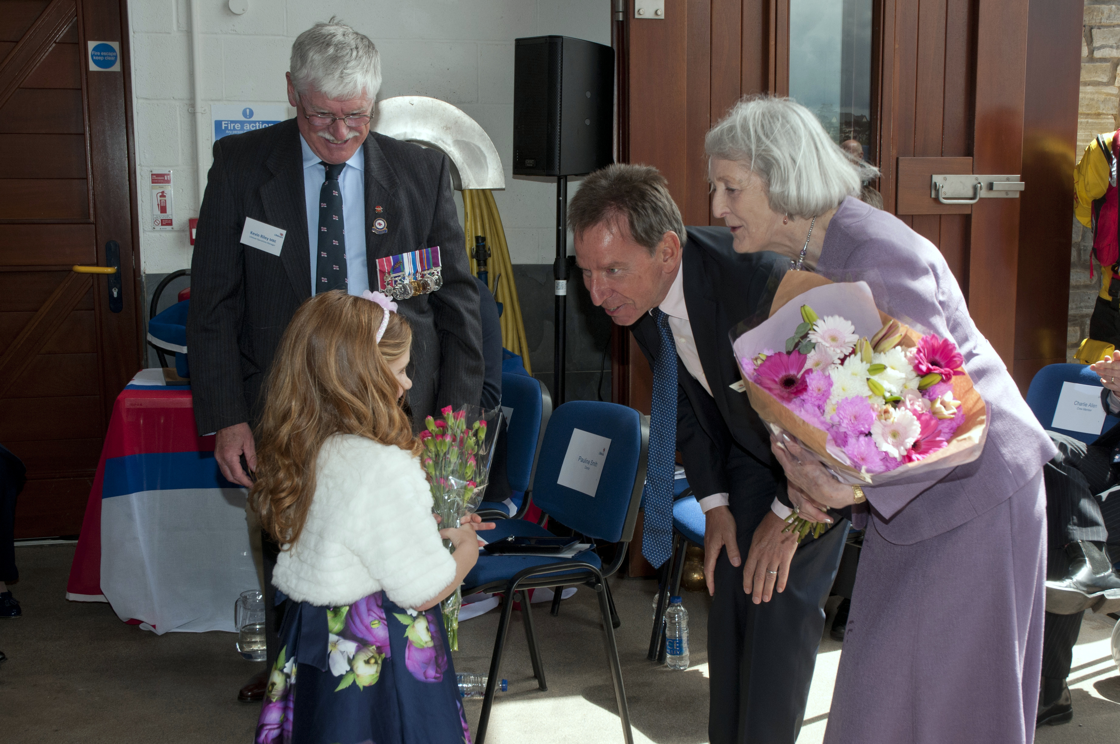 Molly Stott, daughter of Crew volunteer Roy Stott presents and receives flowers at the ceremony
