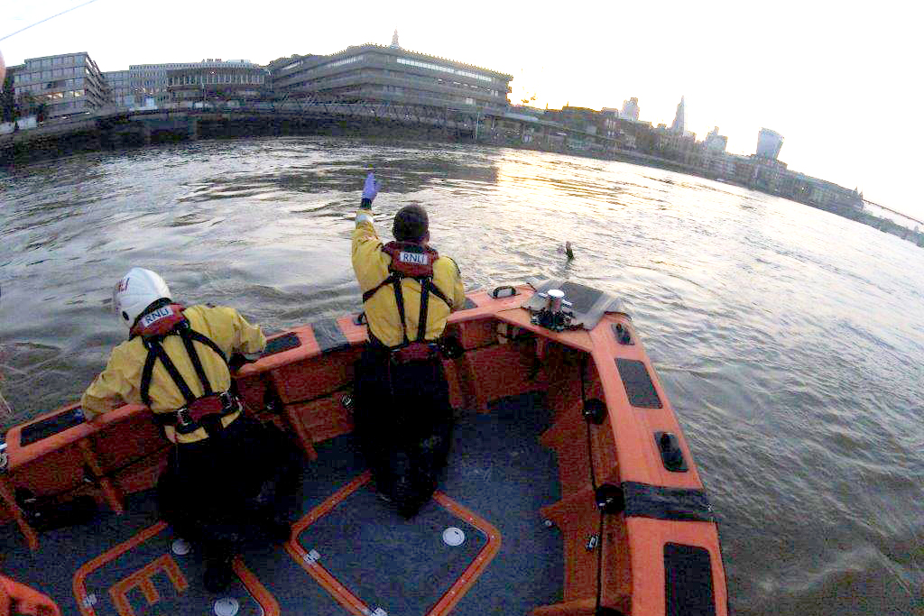 The crew of the Tower RNLI lifeboat close in on the drowning man