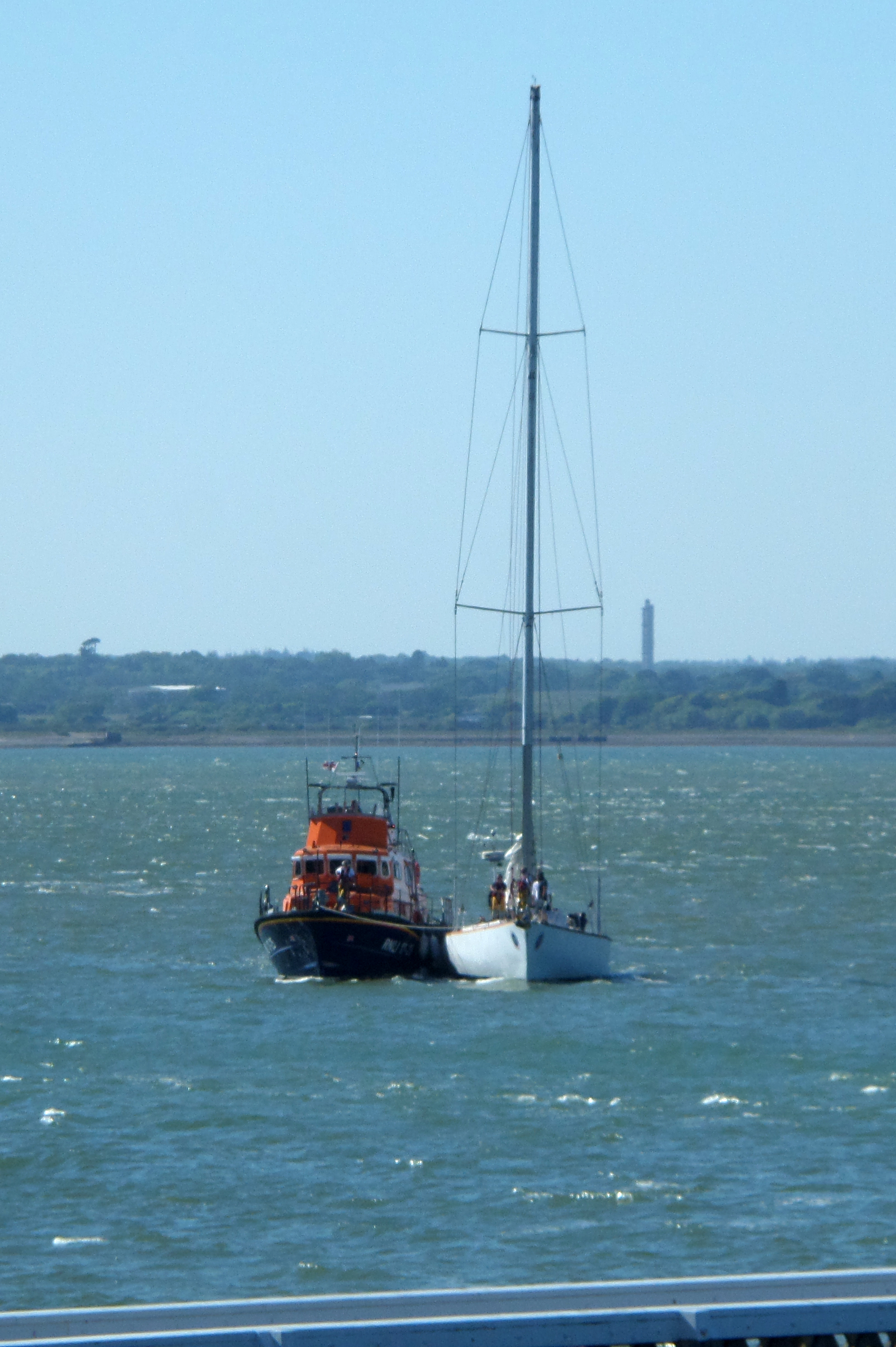 Yacht Great Britain II under tow by the RNLI Yarmouth lifeboat