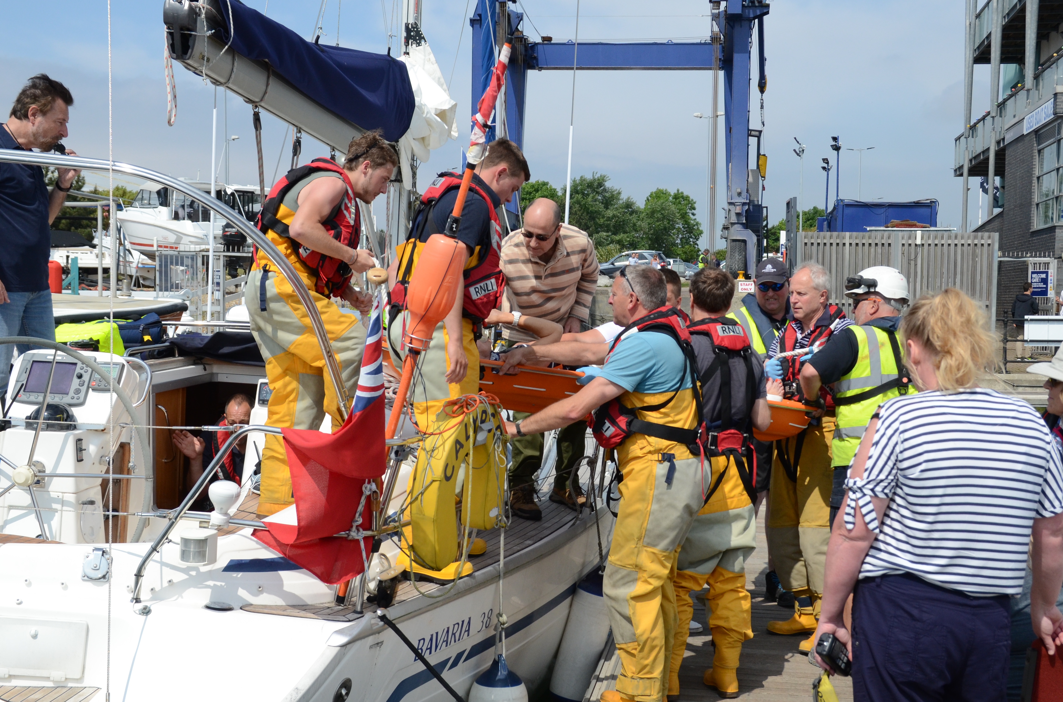 Casualty on stretcher being removed from damaged yacht by lifeboat crew 