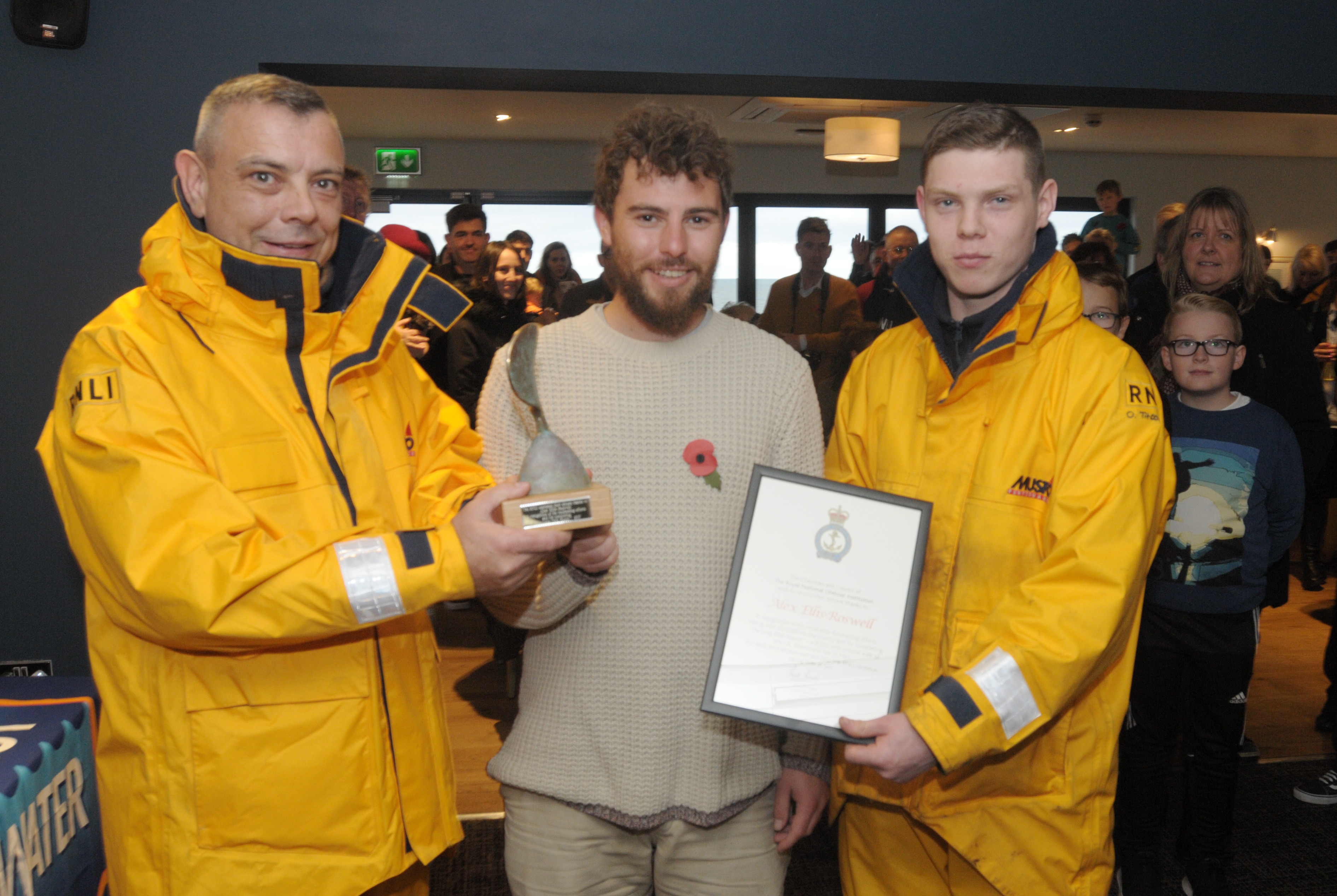 Alex receives awards from the RNLI from Margate crew volunteers Nick and Oliver Titcombe