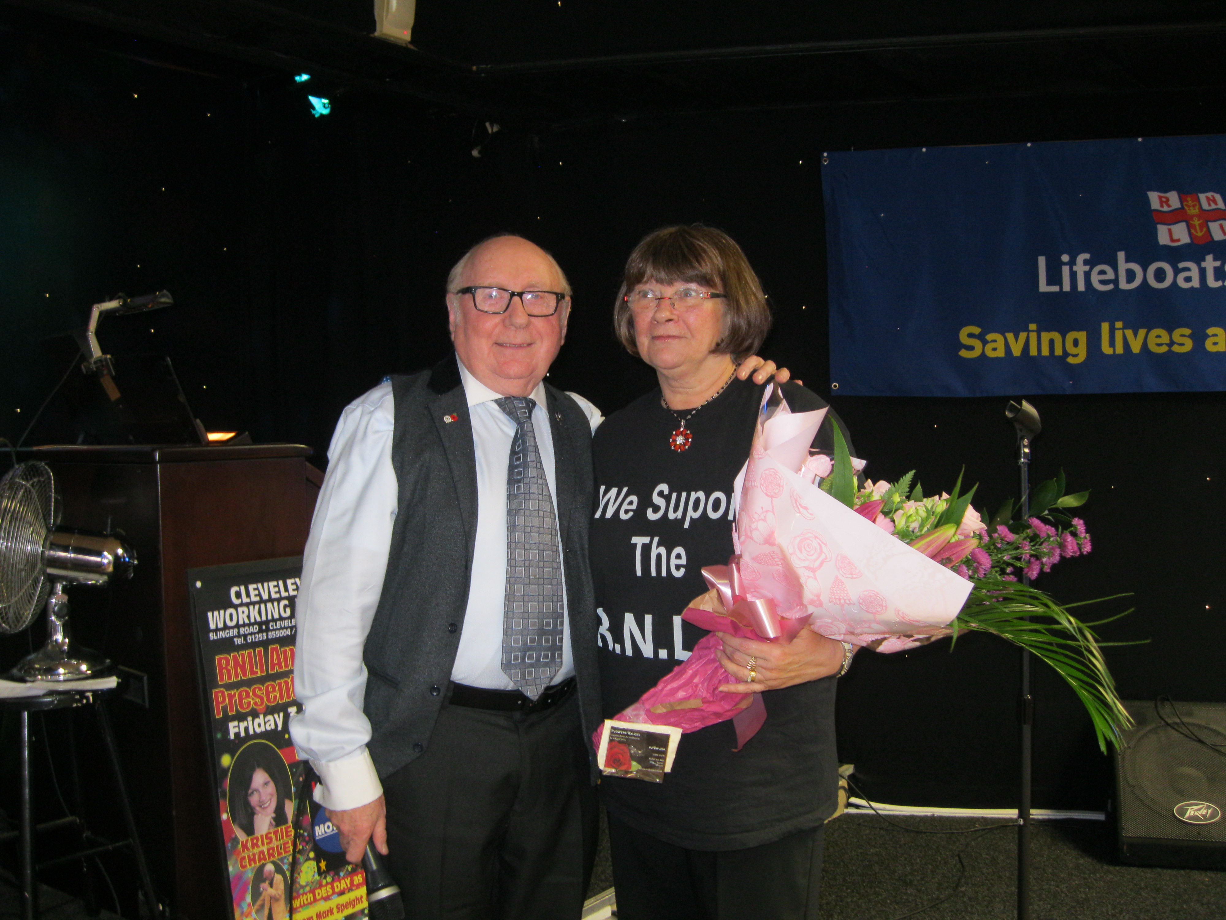 Roy Gaskell presenting bunch of flowers to amazing fundraiser, Avis Coburn 