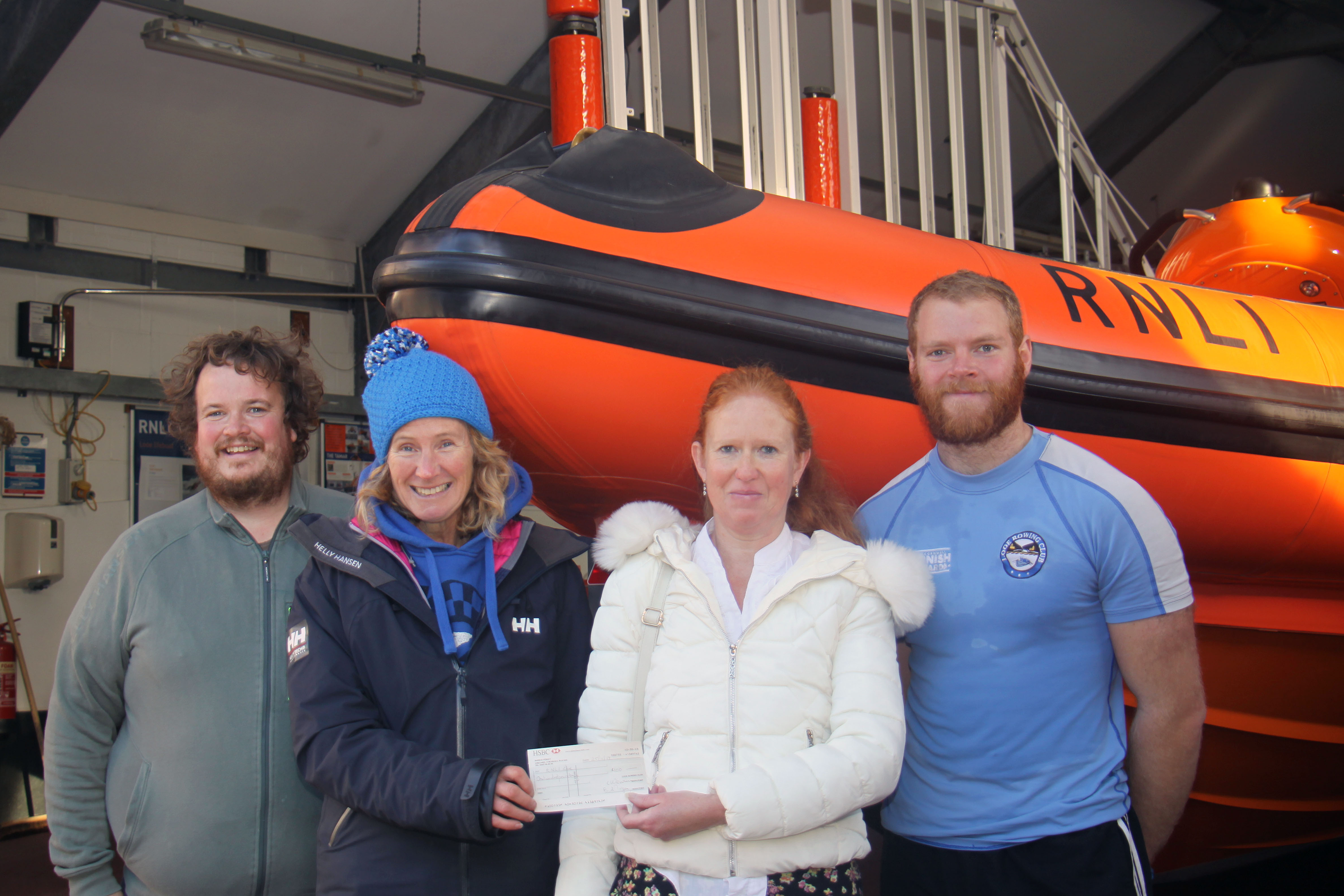 Cheque presentation left to right James Chudleigh (Looe Rowing Club and Looe RNLI Crew ) Emma Cox Jeanette Deakin ( Looe RNLI Treasurer) Nathaniel Rothwell (Looe Rowing Club and Looe RNLI Crew )