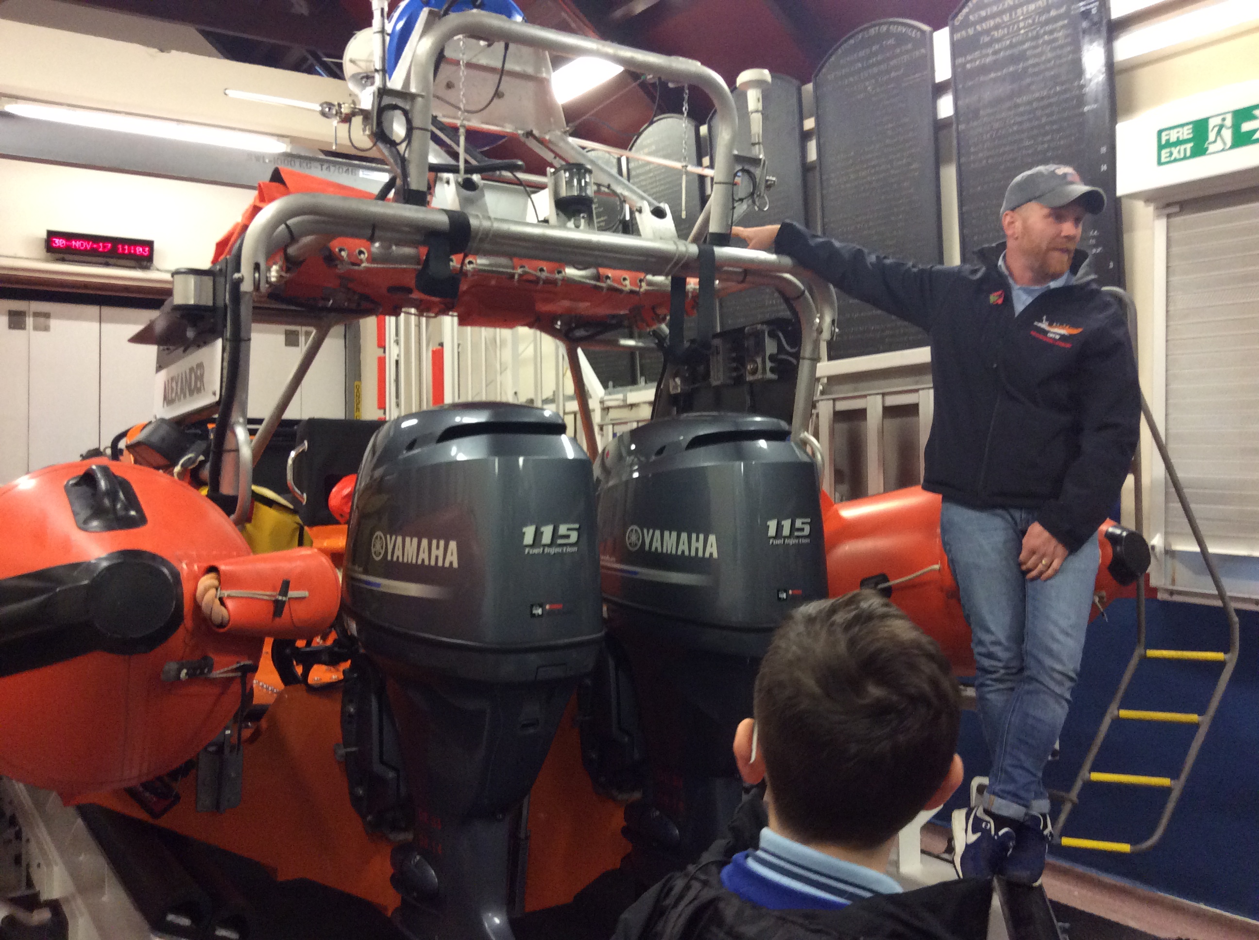 Students receive an update on the engines and boat A frame