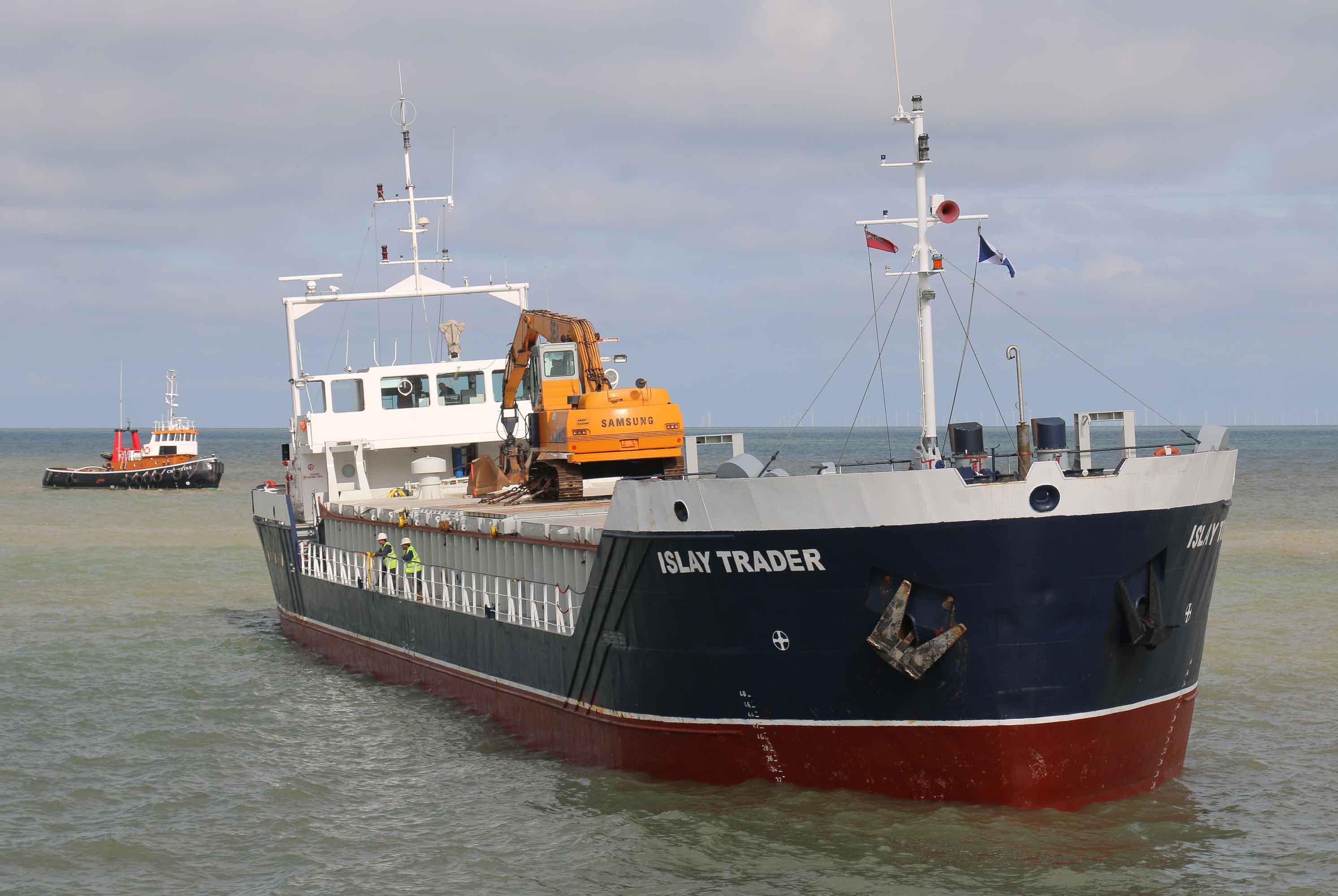 The tug prepares to connect a towline.