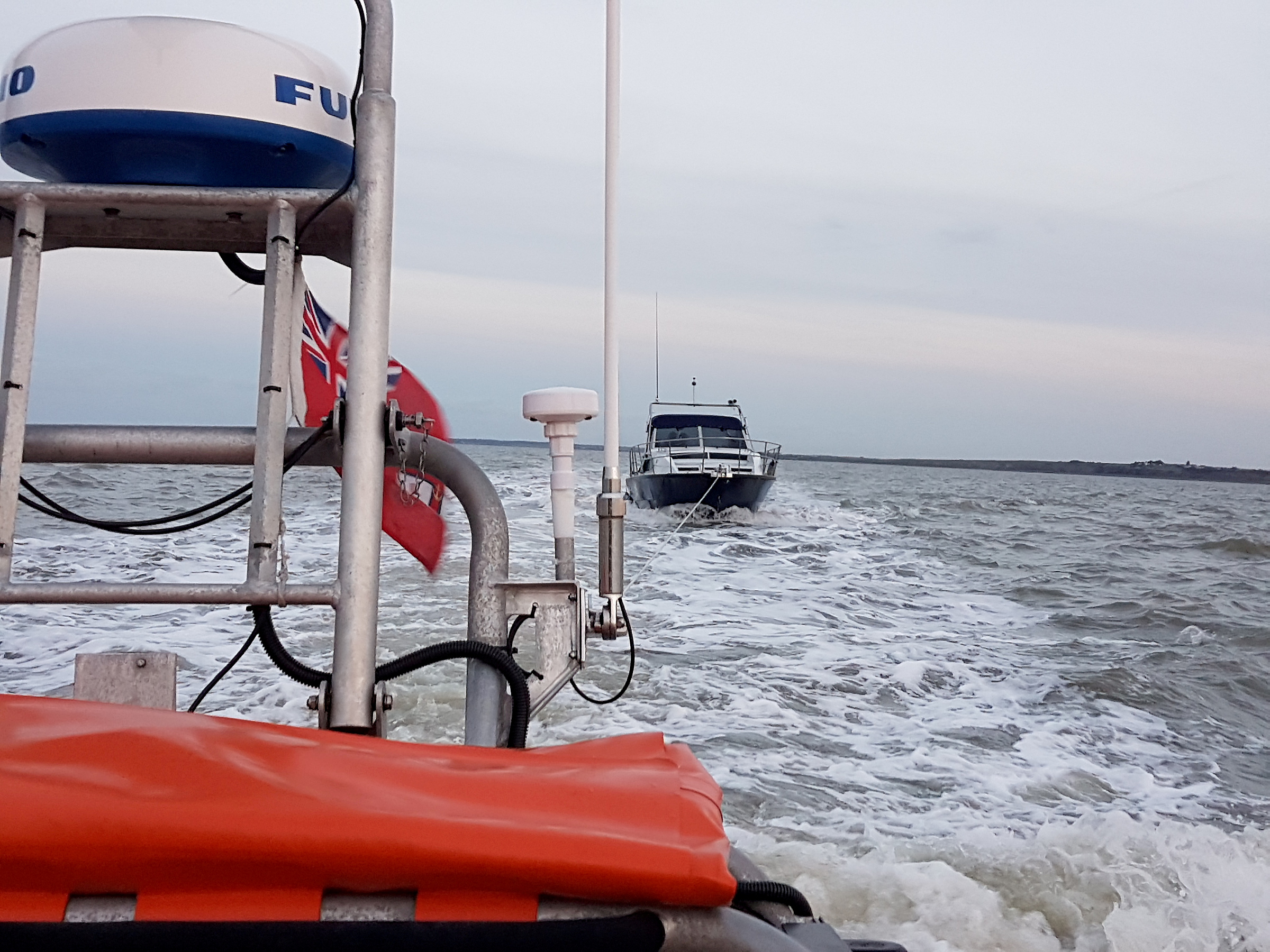 The 30-foot motor cruiser under tow by the Whitstable lifeboat after it suffered a fouled propeller off Herne Bay on Friday evening.