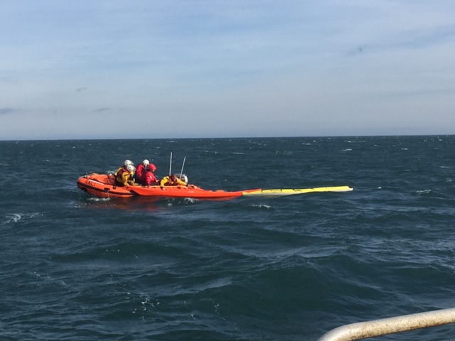 Photograph taken from fishing vessel Boy Alan of kayakers