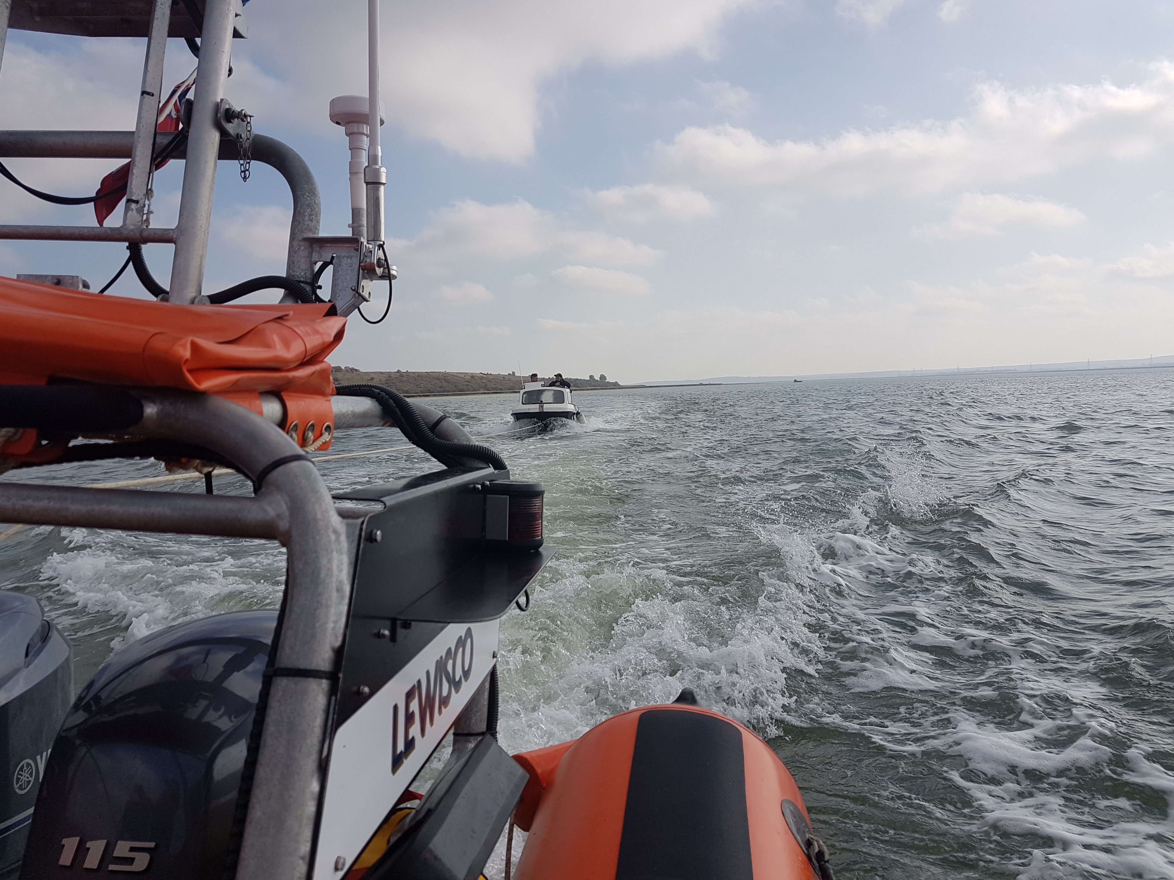 The 14-foot angling boat under tow by the Whitstable Lifeboat after it broke down in the entrance to The Swale on Sunday morning. Picture: Tim Smith/RNLI Whitstable