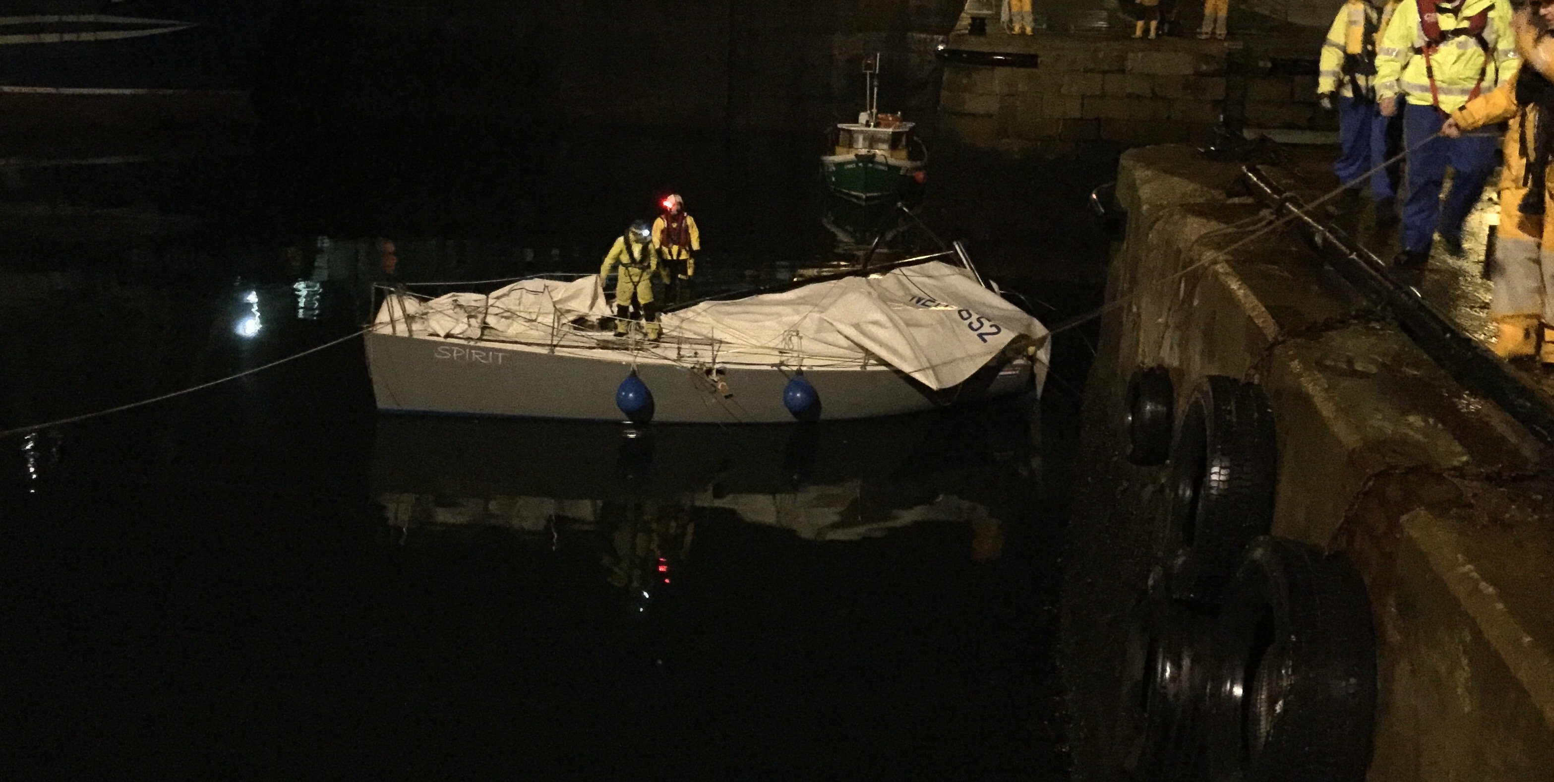 Picture showing Yacht Spirit with damage to the port beam. Yachtsman and RNLI crew member on board