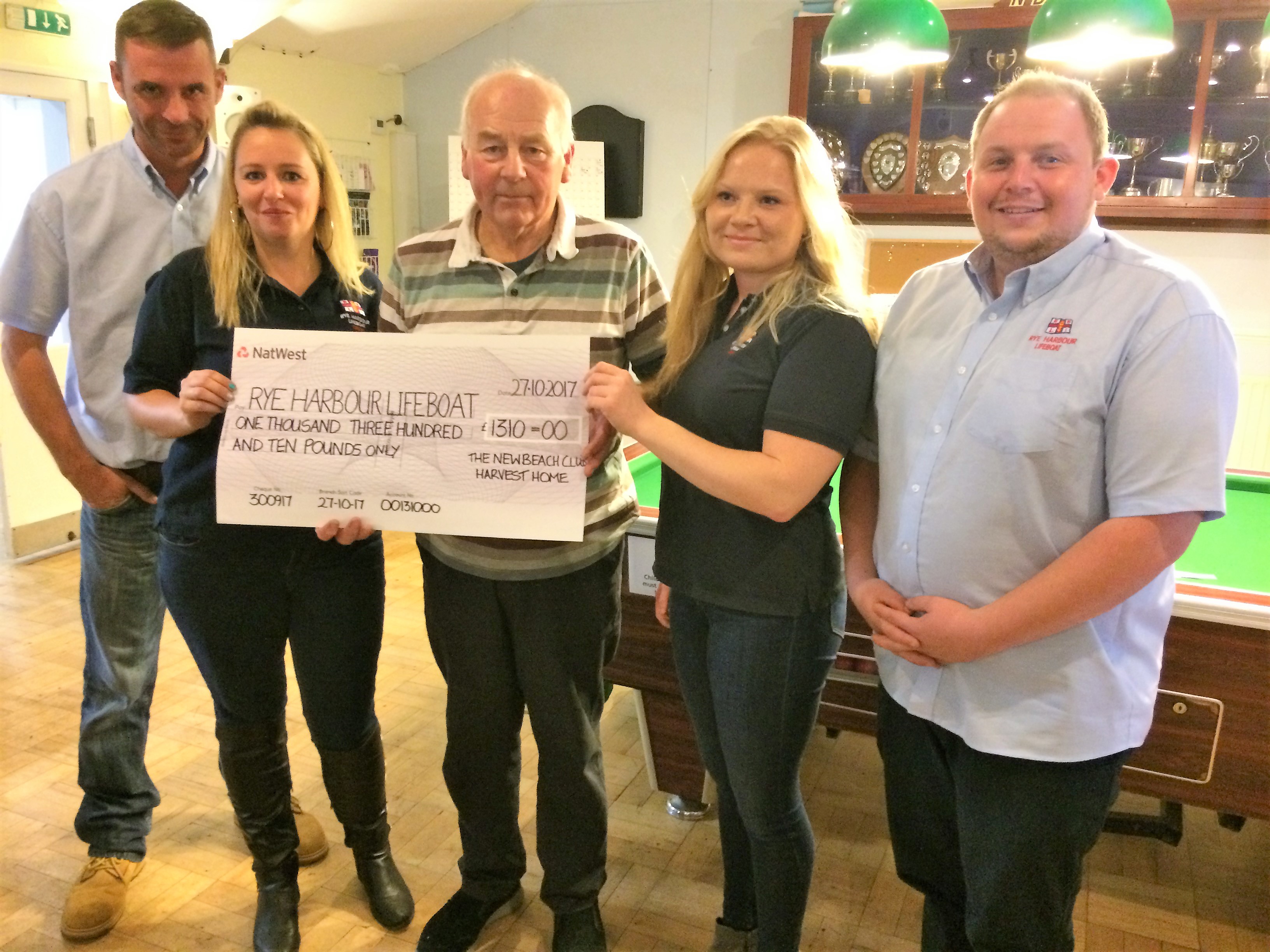 Peter Drew and members of the Rye Harbour crew with their cheque. From left to right Tony Peters, Natalie Arter, Alissia Matthews and Joe Brown