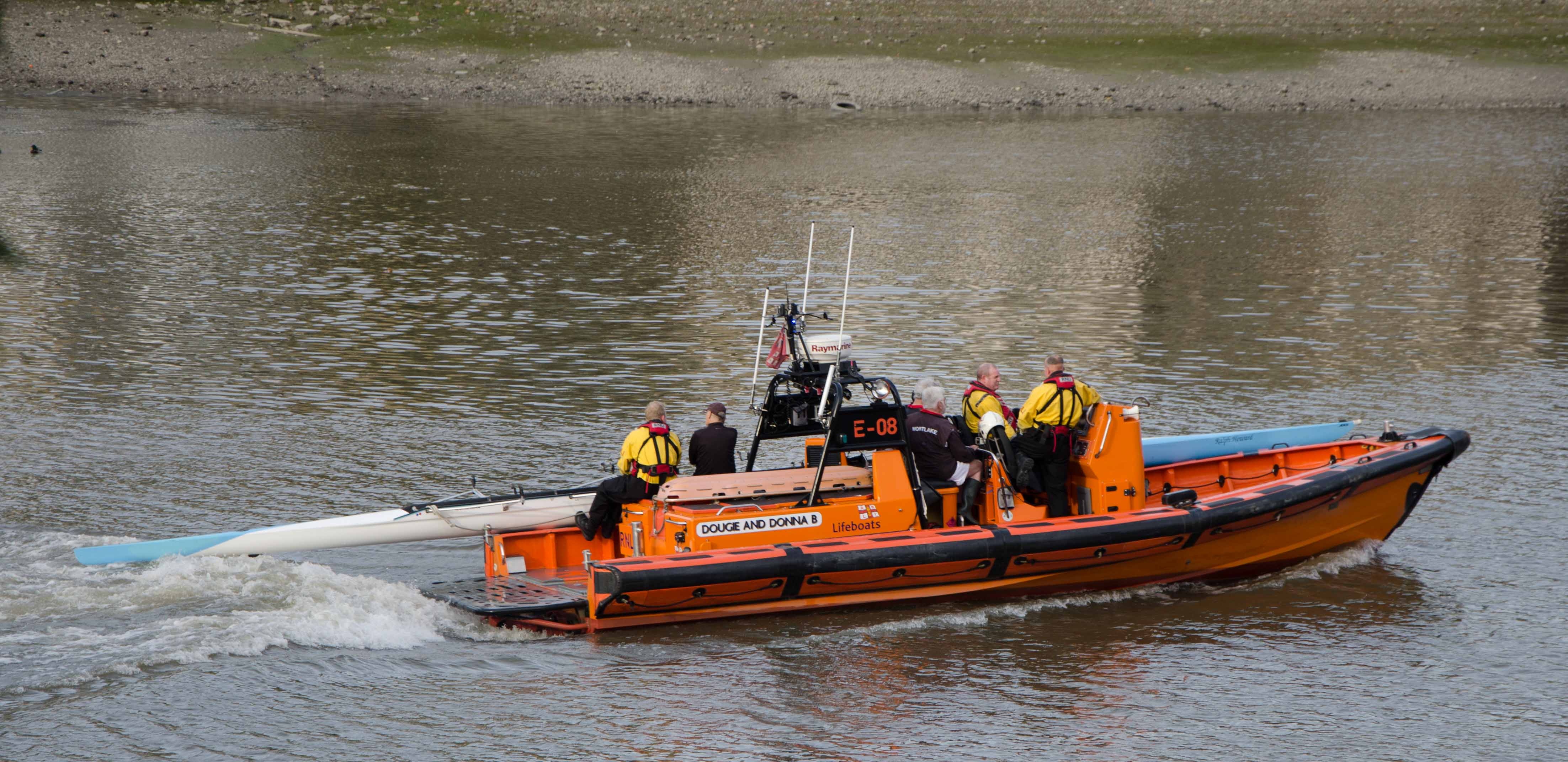 Four veteran rowers and their damaged craft being taken back to their base