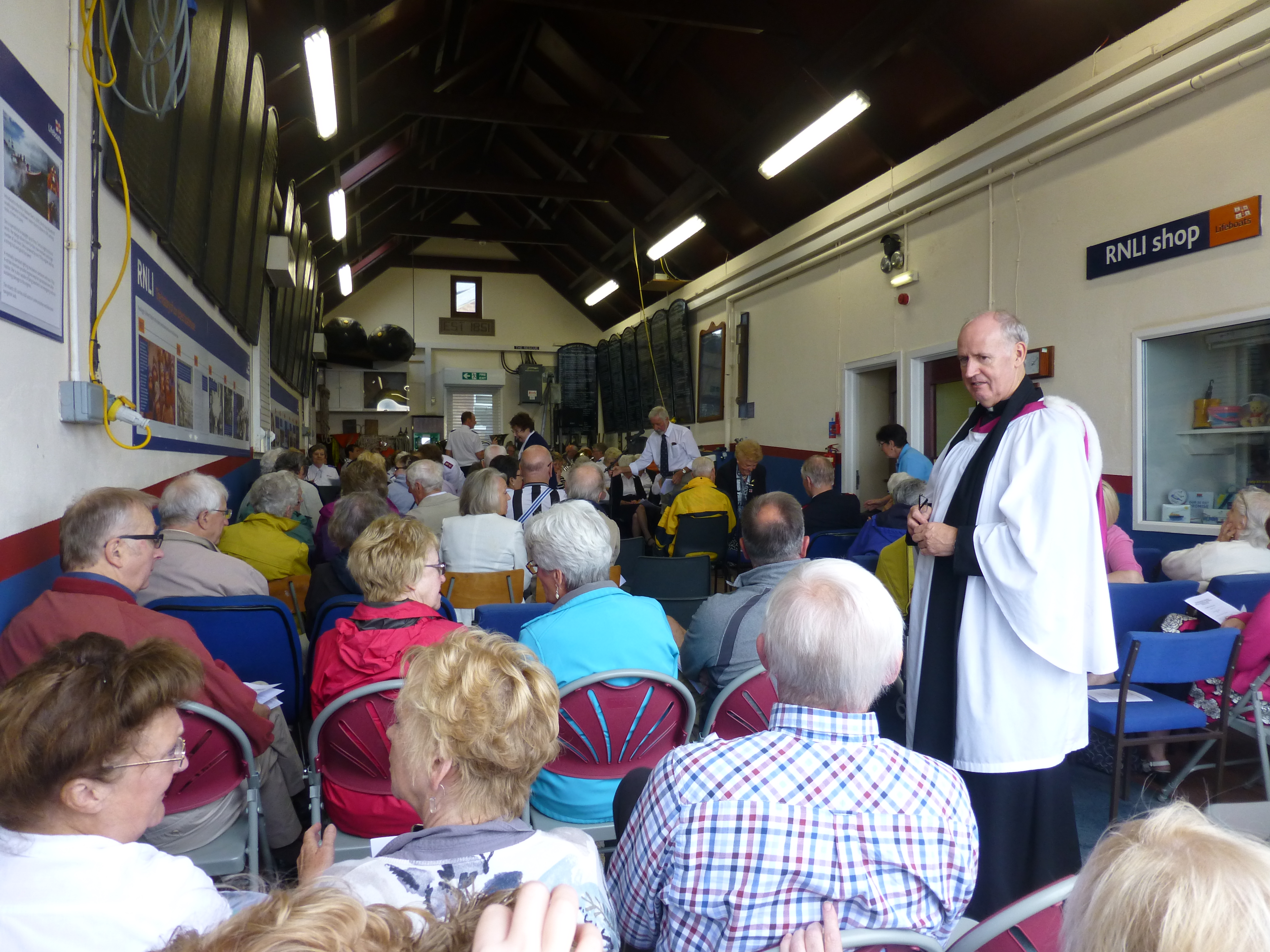 Peter welcomes visitors to the annual service within the lifeboat boathouse
