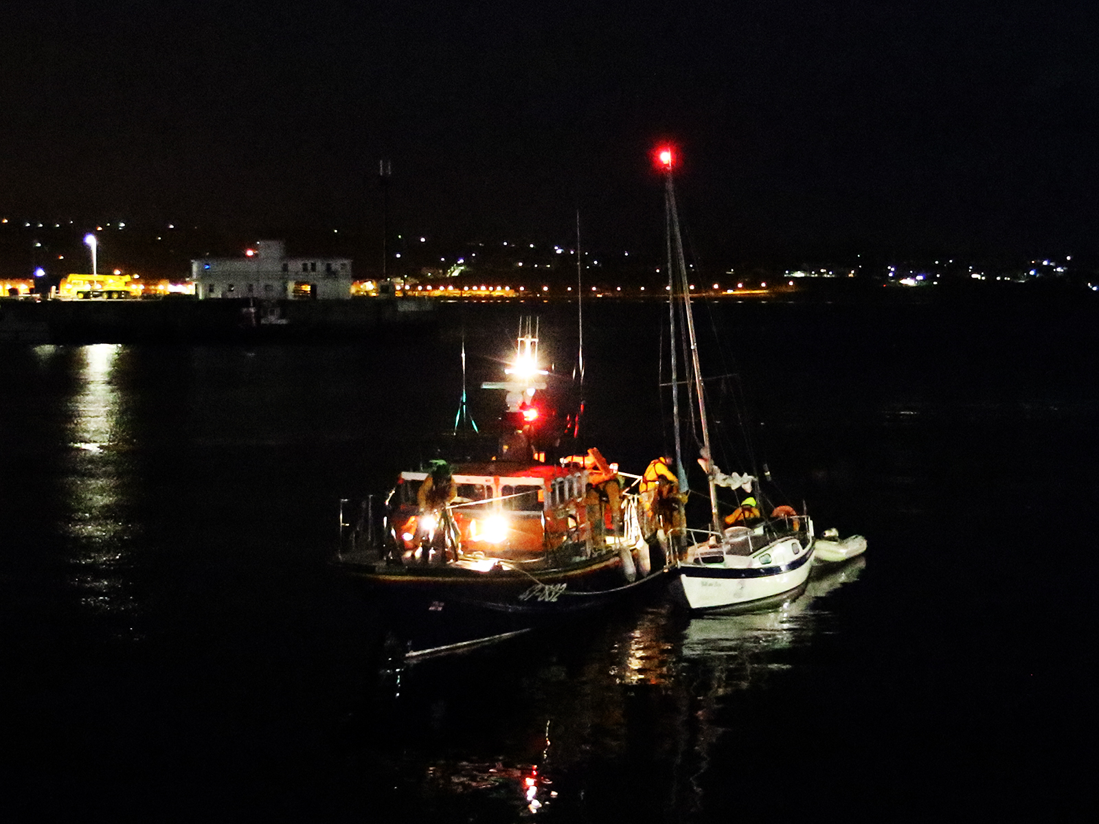 Douglas lifeboat Sir William Hillary with casualty vessel in Douglas harbour