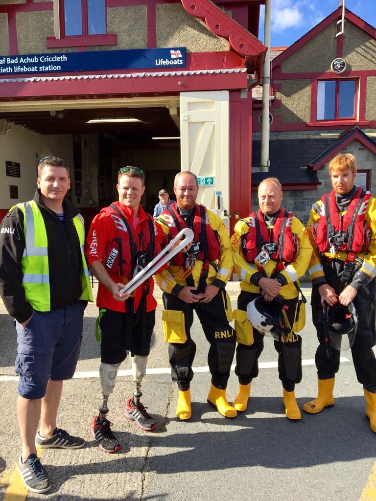 Member of Criccieth's RNLI Lifeboat crew with Paralympian Stephen Thomas