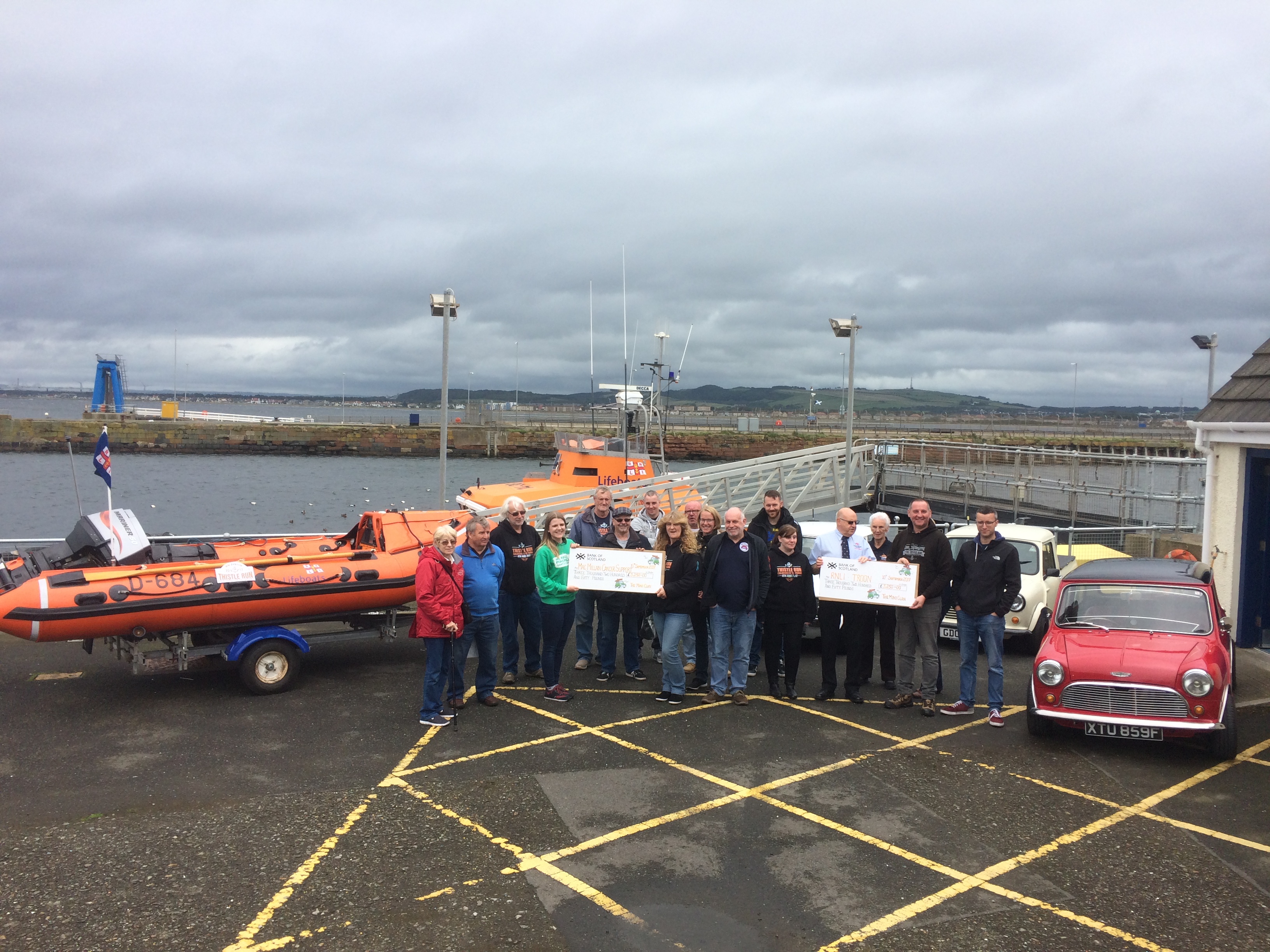 The cheque is handed over at Troon lifeboat station to Lifeboat Operations Manager Dave Shaw