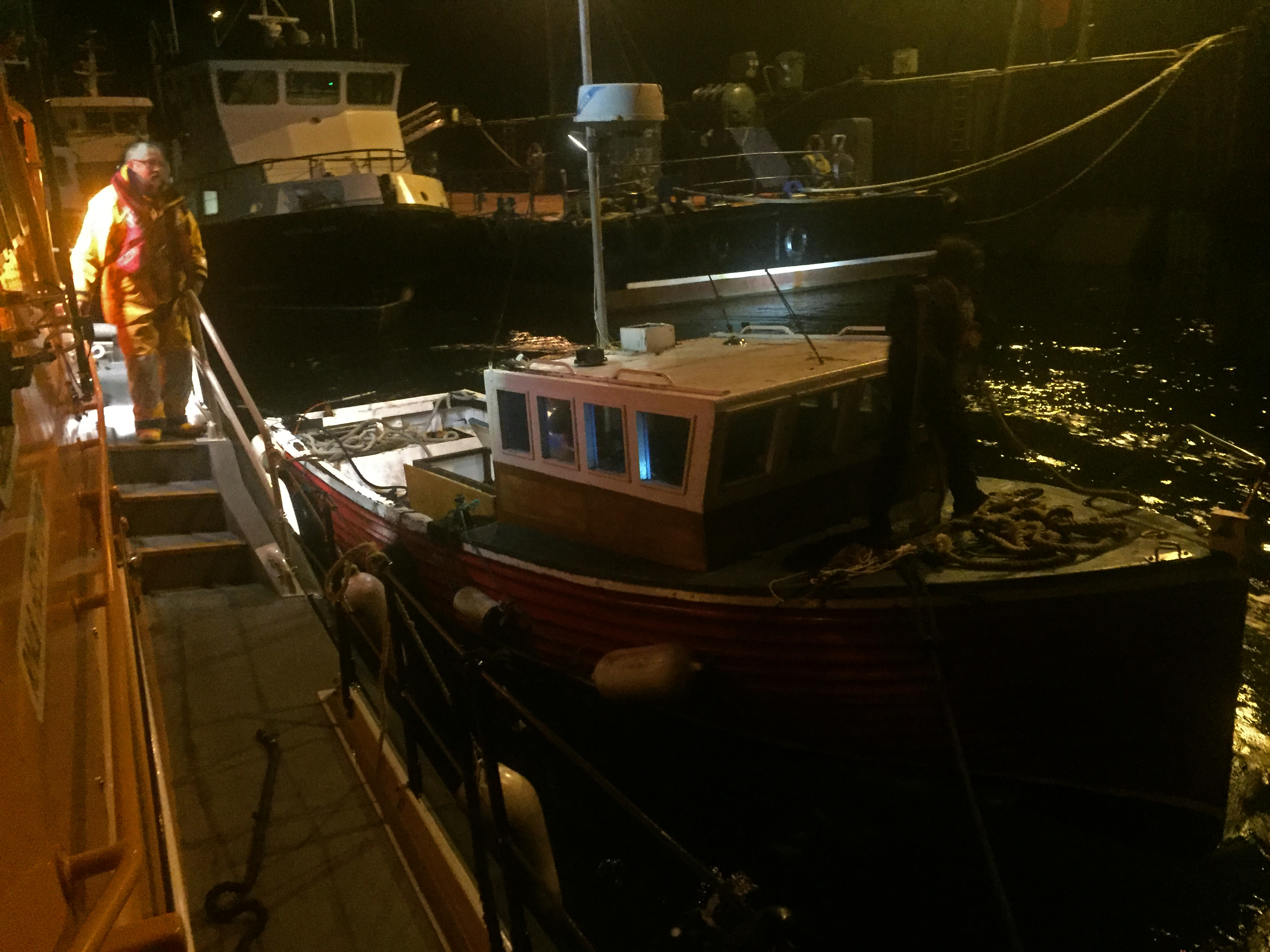 RNLI Longhope Lifeboat brings vessel safely alongside pier at Flotta