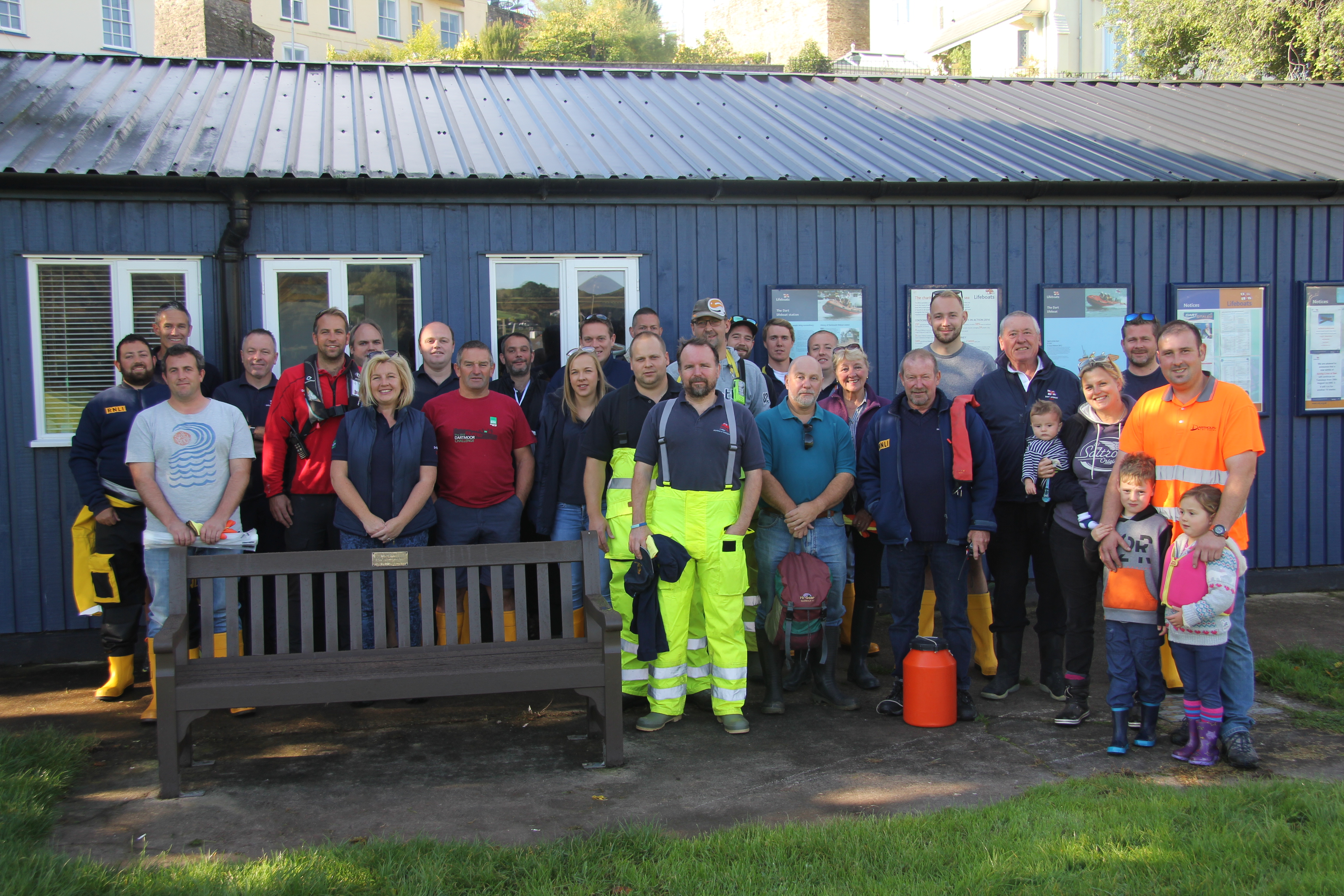RNLI volunteers and Dart Harbour Authority staff posed outside the Dart lifeboat station before the Dart River Clean Up.