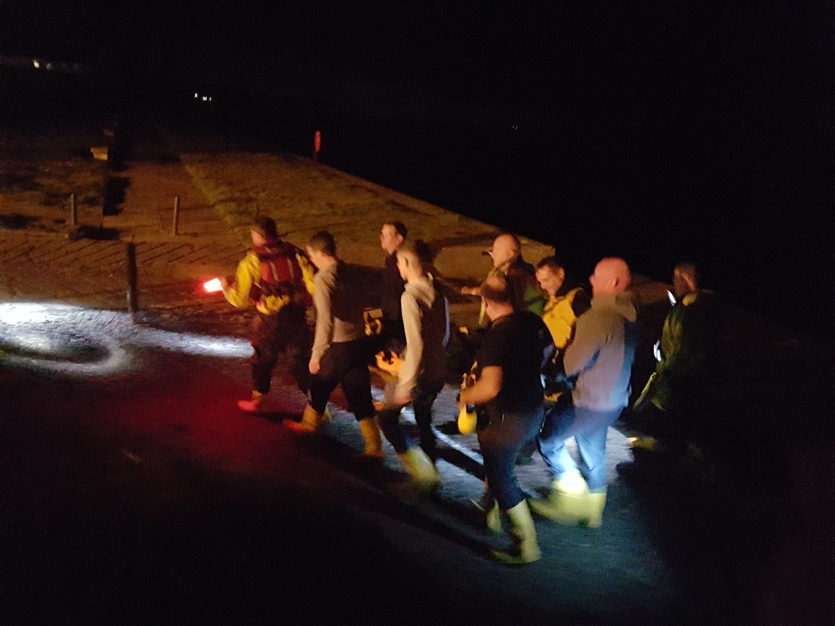 St Bees RNLI volunteers bringing the injured youngster back from up the rocks