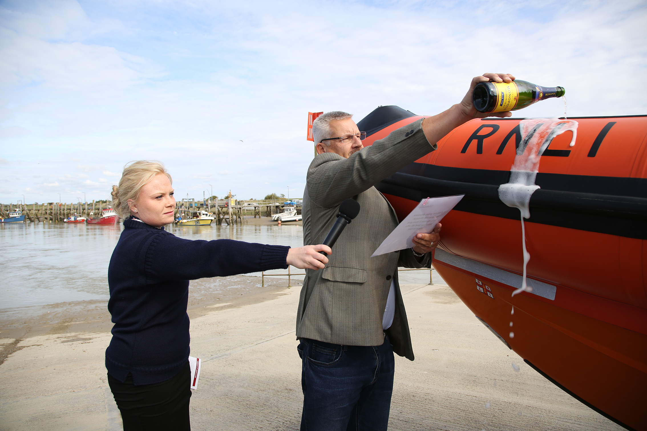 Nigel Carter officially names Hello Herbie II whilst crew member Alissia Matthews holds the mike.