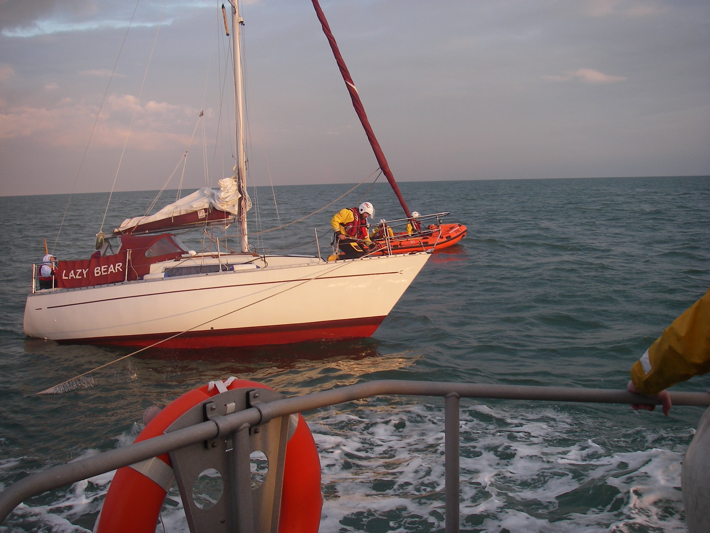 tow line being attached to the yacht by a lifeboat crewmember