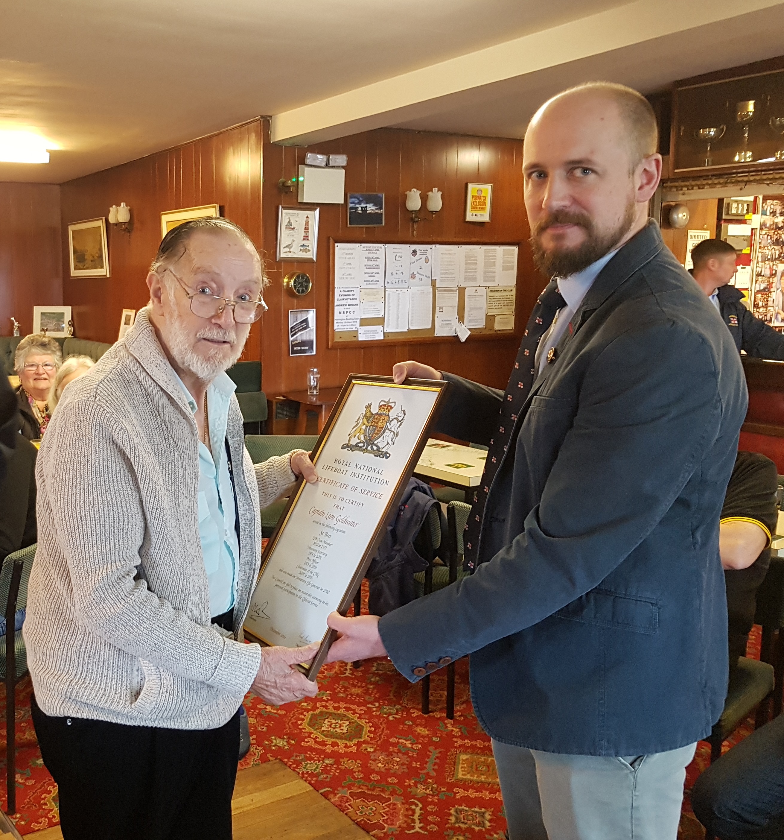 RNLI Area Lifesaving Manager Saul Mendelssohn presenting RNLI volunteer Captain Leon Goldwater with his Certificate of Service