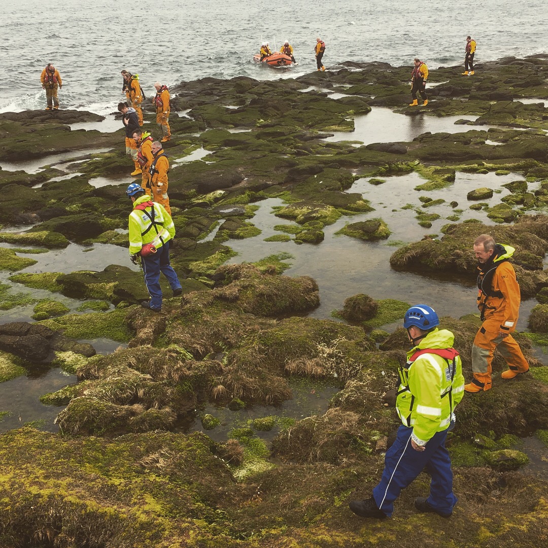 Troon lifeboat crew and coastguard teams carrying out a search across a rocky coastline for a missing person