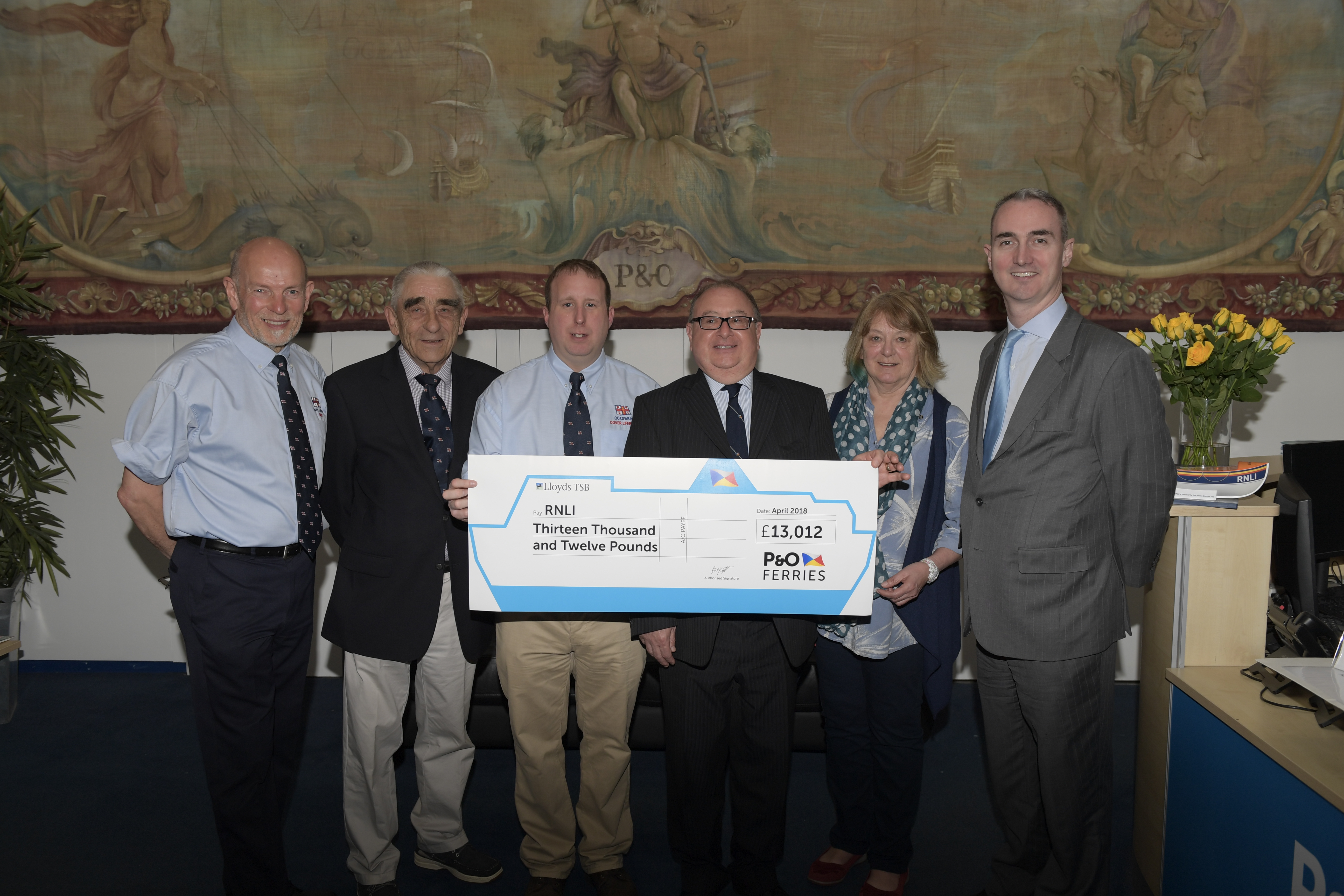 Staff from the company present Dover RNLI with fundraising cheque for £13,012.