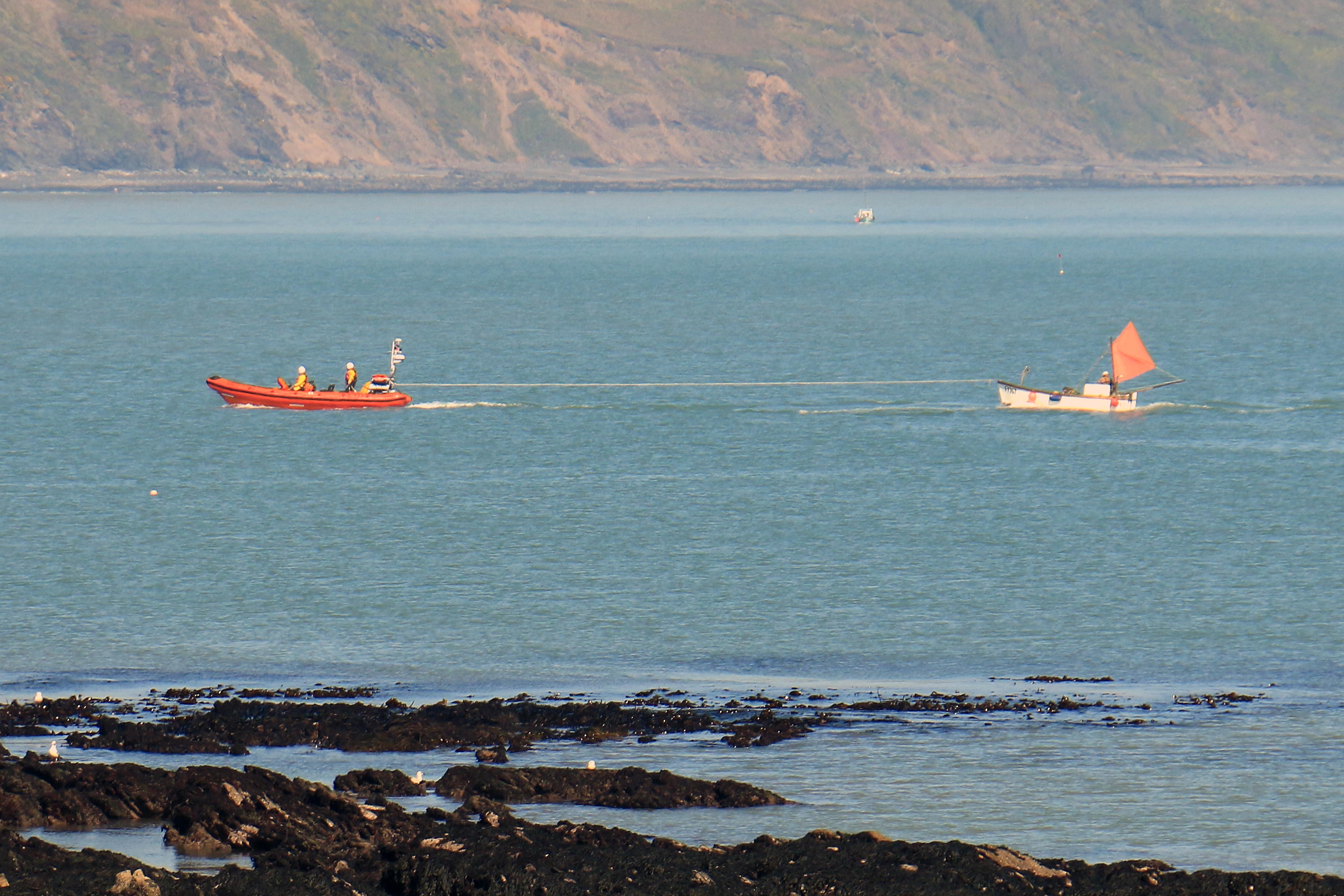Looe RNLI’s Atlantic 85 Sheila and Dennis Tongue II towing the crabber towards Looe