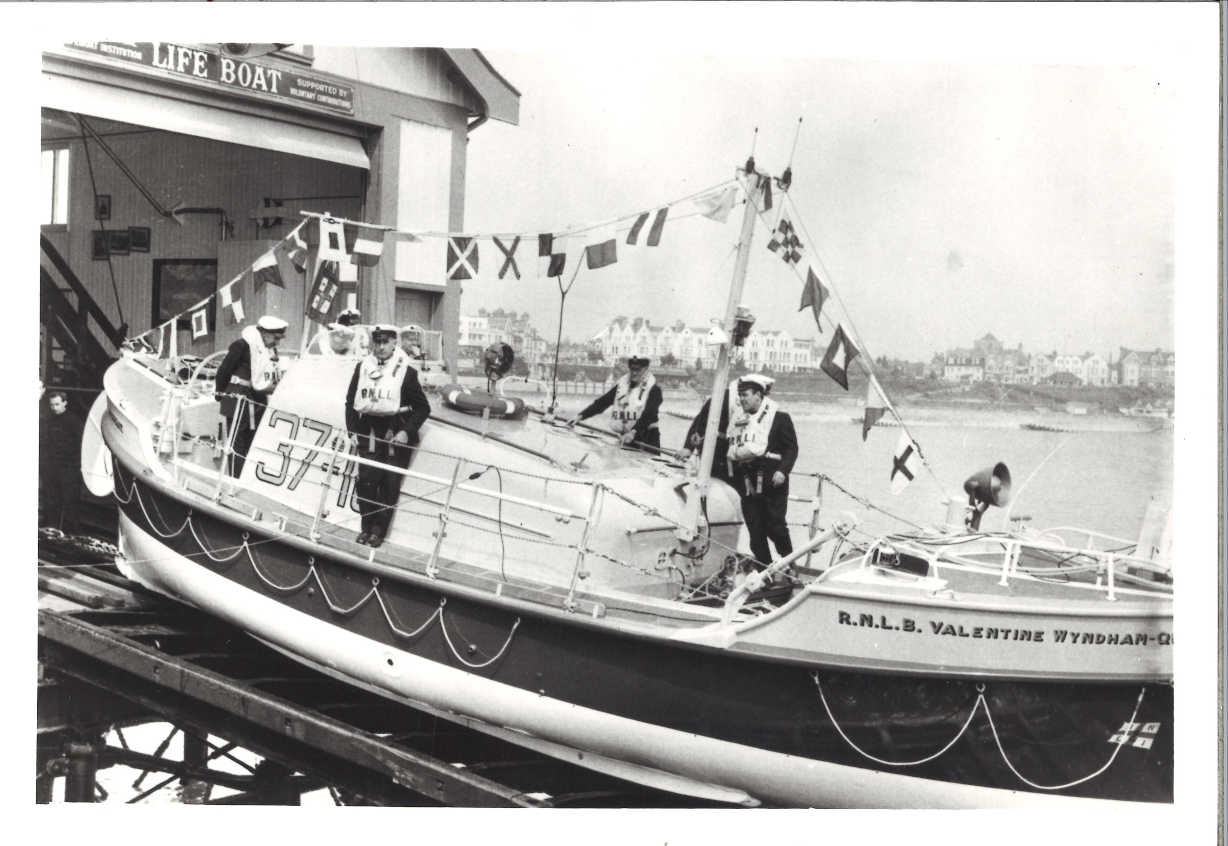 crew standing aboard the Valentine Wyndham Quin during naming ceremony, with all the bunting out